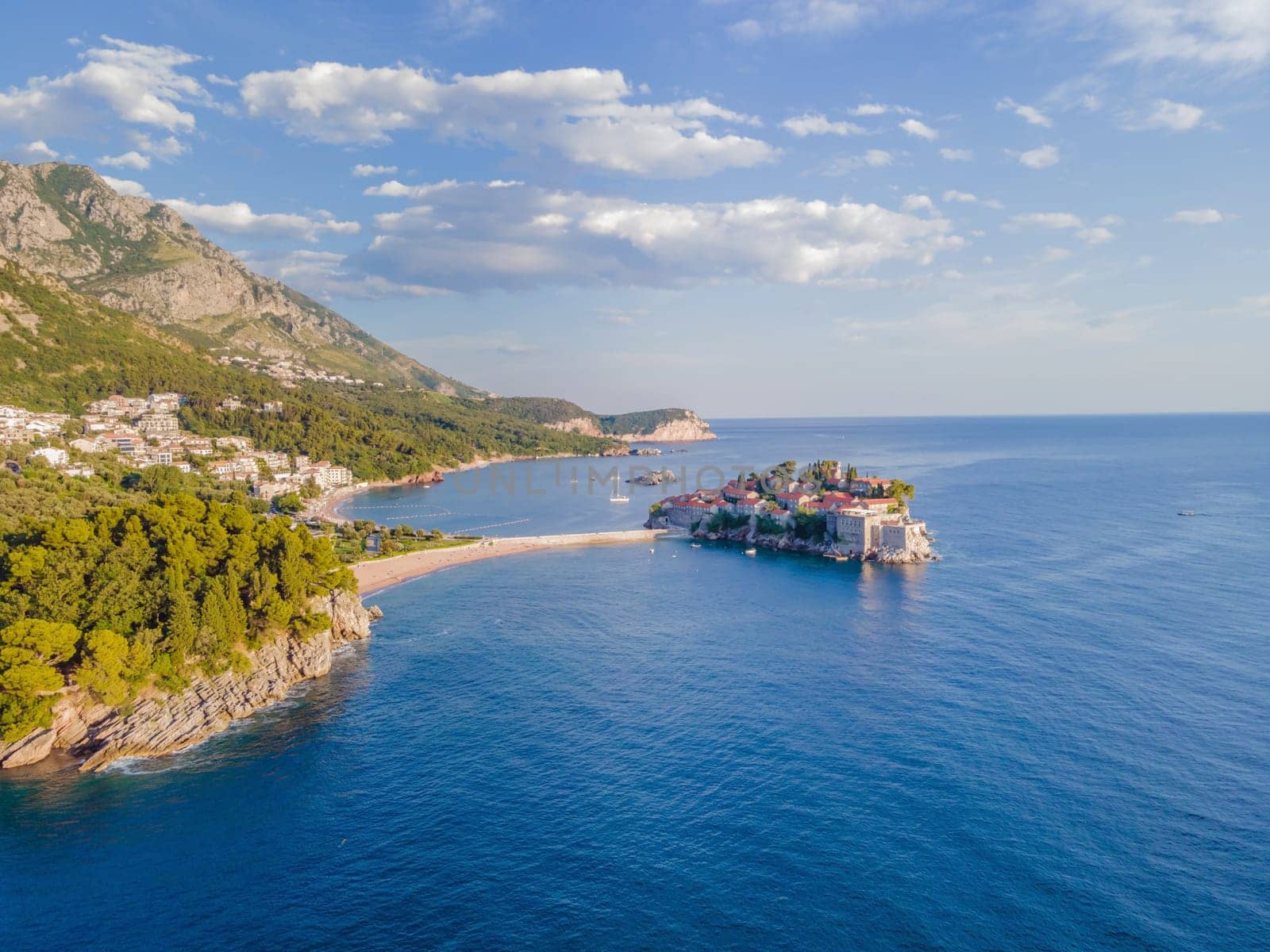 Aerophotography. Aerial view of Sveti Stefan island in a beautiful summer day, Montenegro from flying drone. Panoramic above view of Saint Stephen luxury resort. Tourism and leisure concept by galitskaya