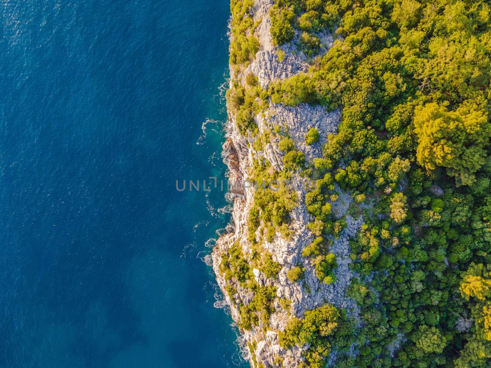 Aerial view of sea waves and Rocky coast in Montenegro by galitskaya