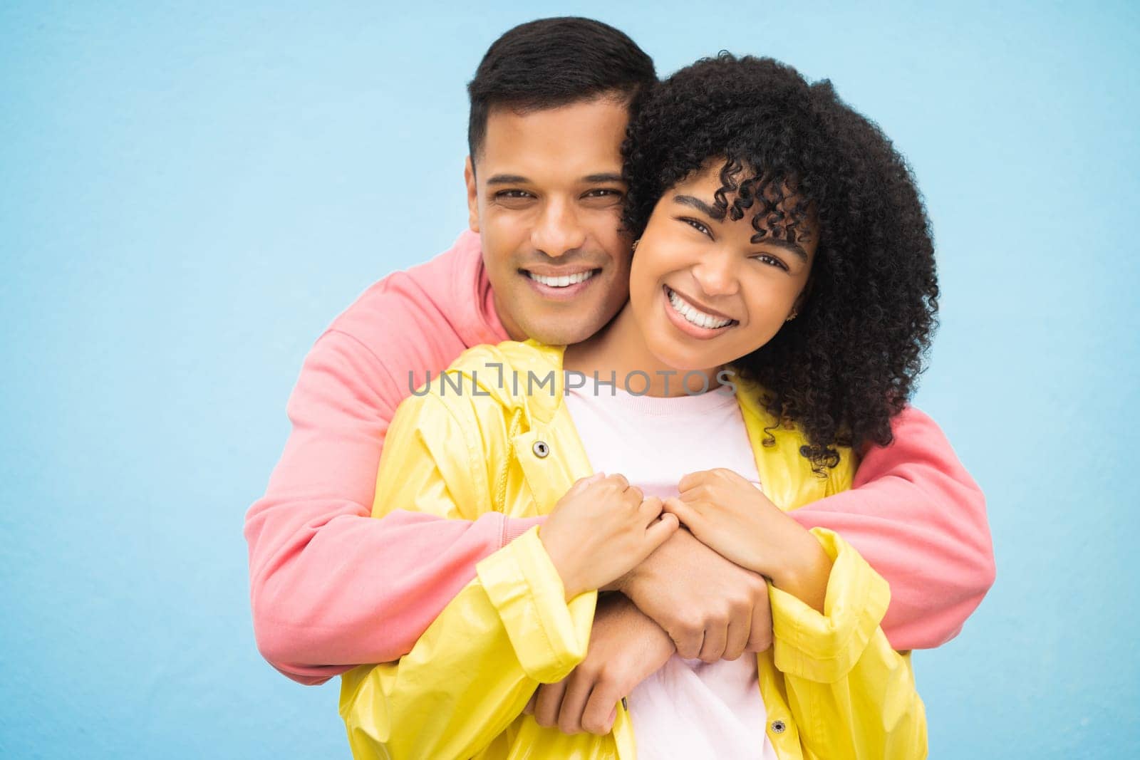 Happy people, smile and hug in portrait with couple in love, commitment isolated on blue background. Interracial relationship mockup, commitment and together in studio with black woman, man and trust.