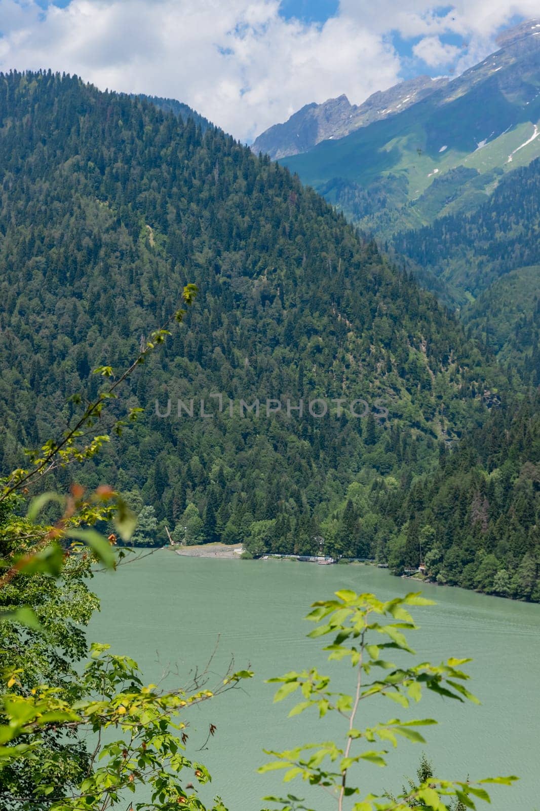 View on the turquoise color lake between high and rocky mountains. Beautiful alpine landscape.