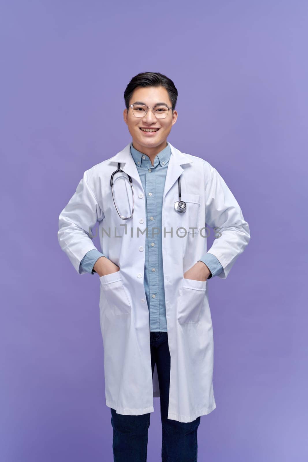 portrait of friendly Asian doctor man at his office smiling to camera