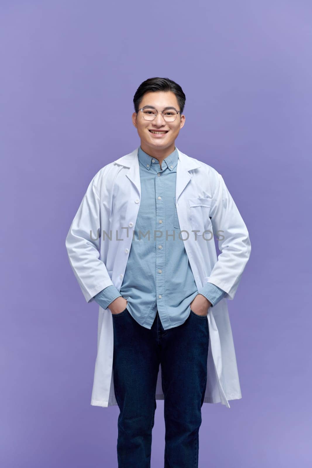 portrait of friendly Asian doctor man at his office smiling to camera