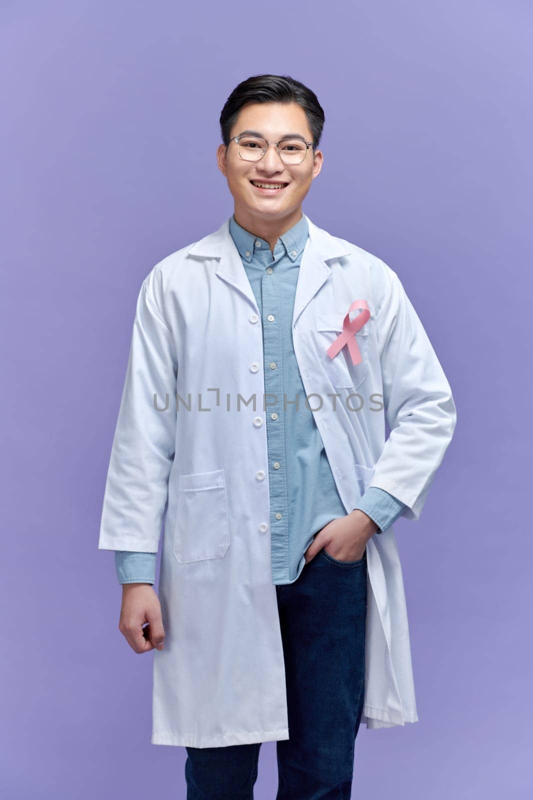 male doctor with pink ribbon. Cancer concept by makidotvn