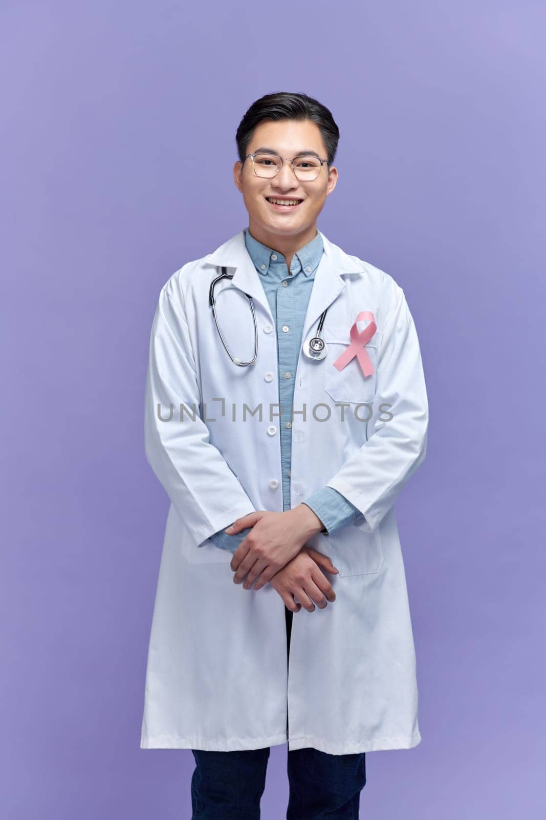 male doctor with pink ribbon. Cancer concept