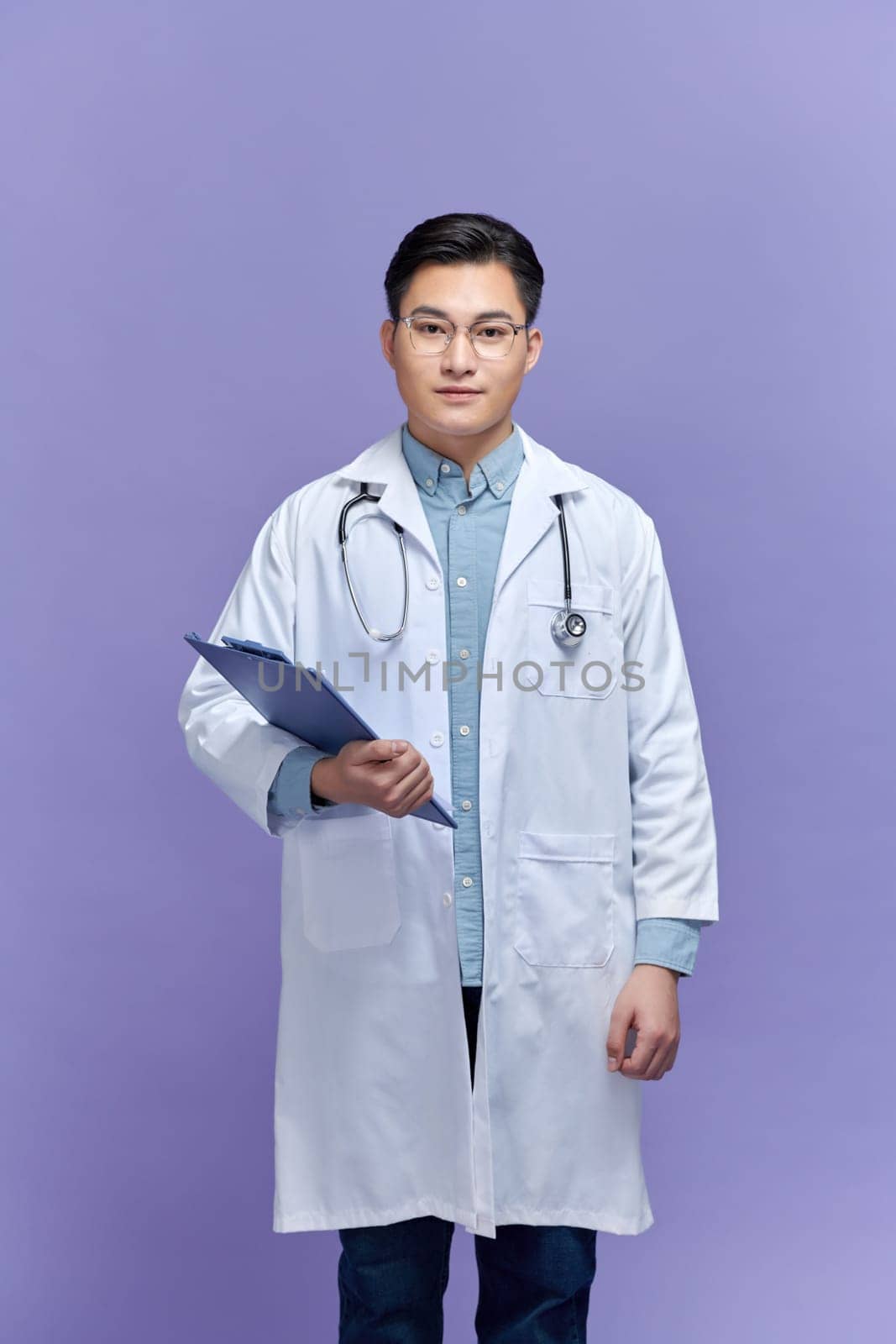 Male Doctor holding clipboard isolated on white