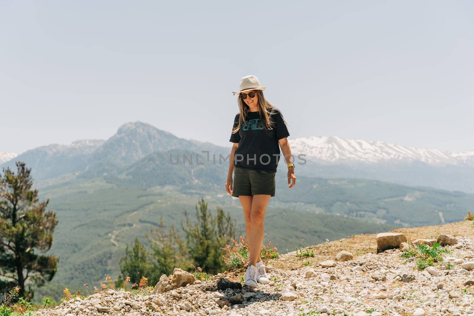 Young woman in hat standing on Mountain View by Ostanina