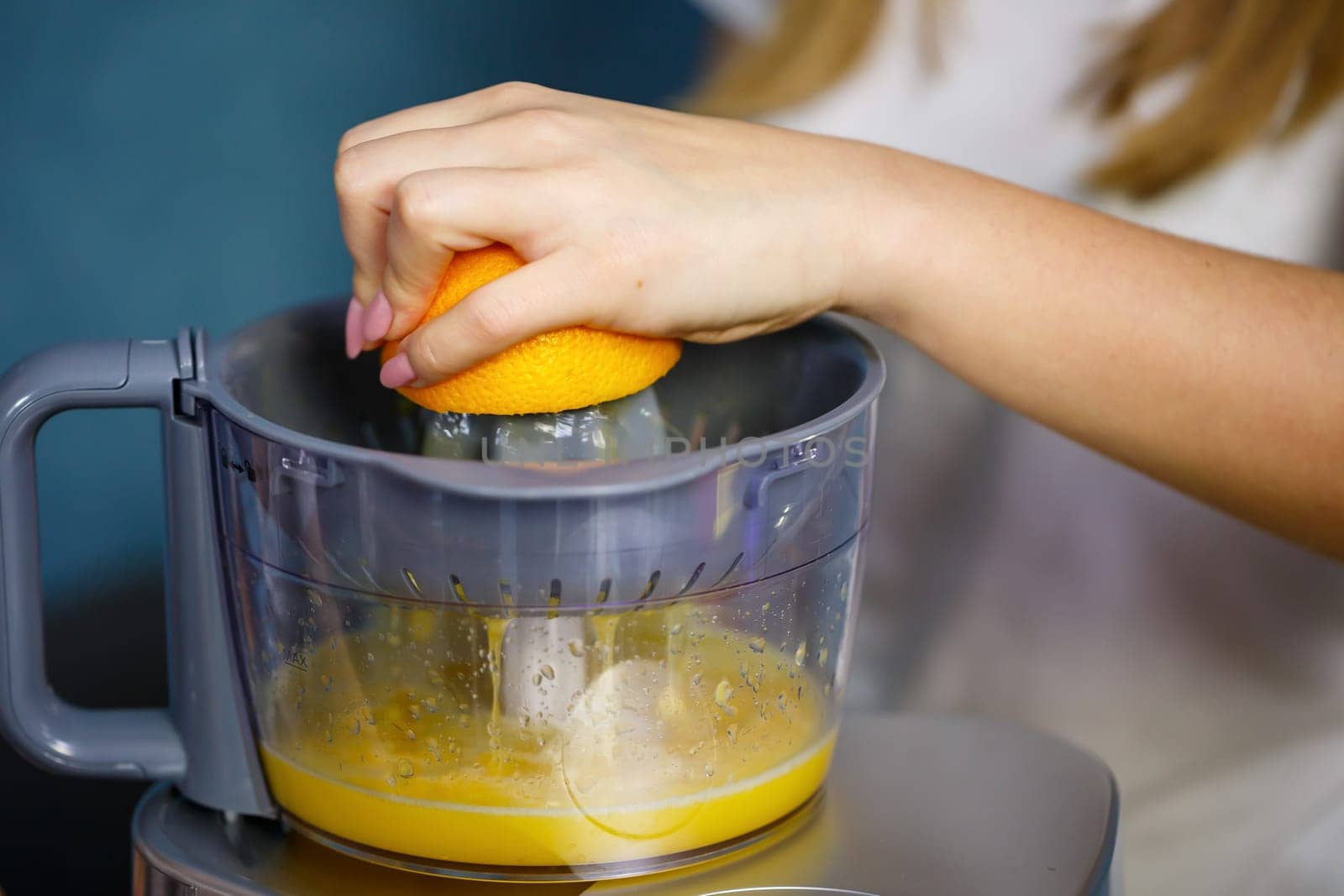 Little girl squeezed fresh juice from fruits of apples and orange. Vitamins and healthy nutrition for children.