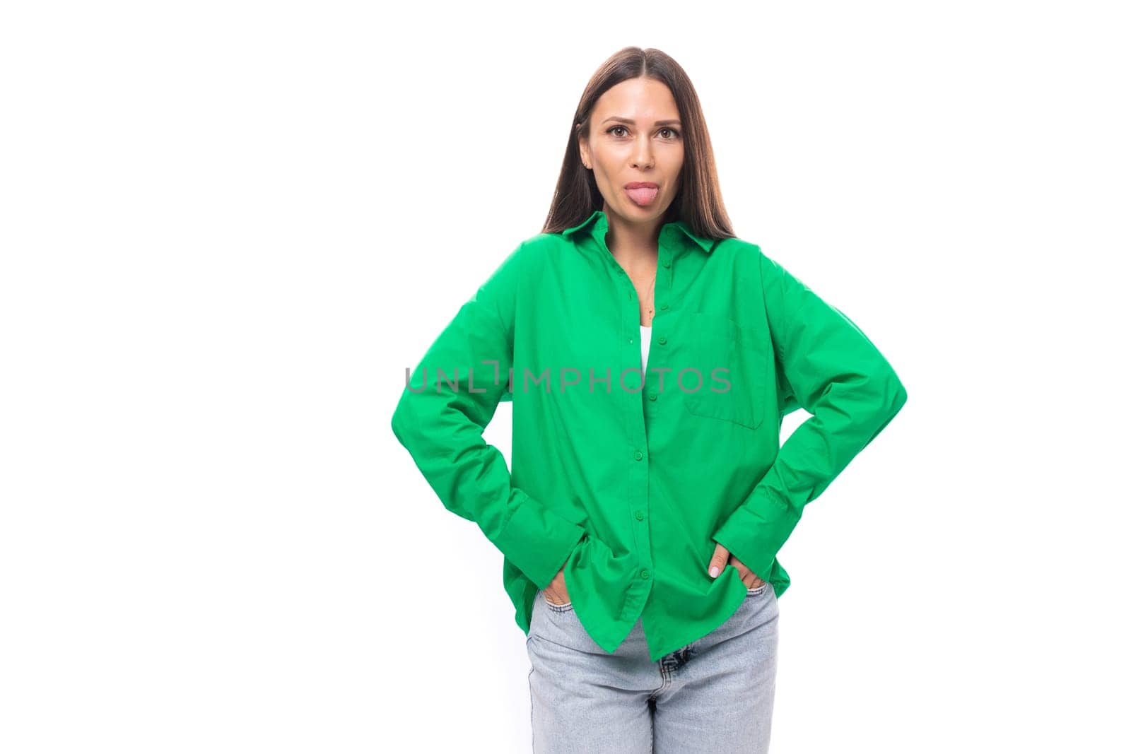 pretty slim european brunette woman with long hair and brown eyes dressed in casual green shirt showing tongue.