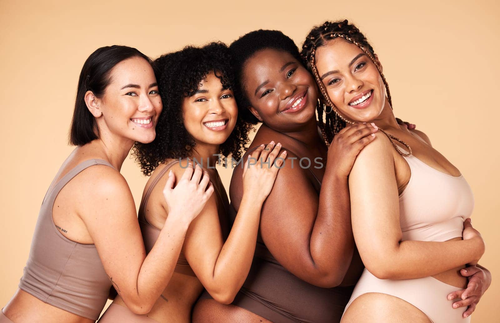 Skin care, portrait and diversity women group together for inclusion, natural beauty and power. Happy plus size model friends on beige background for support, makeup glow and underwear body self love.