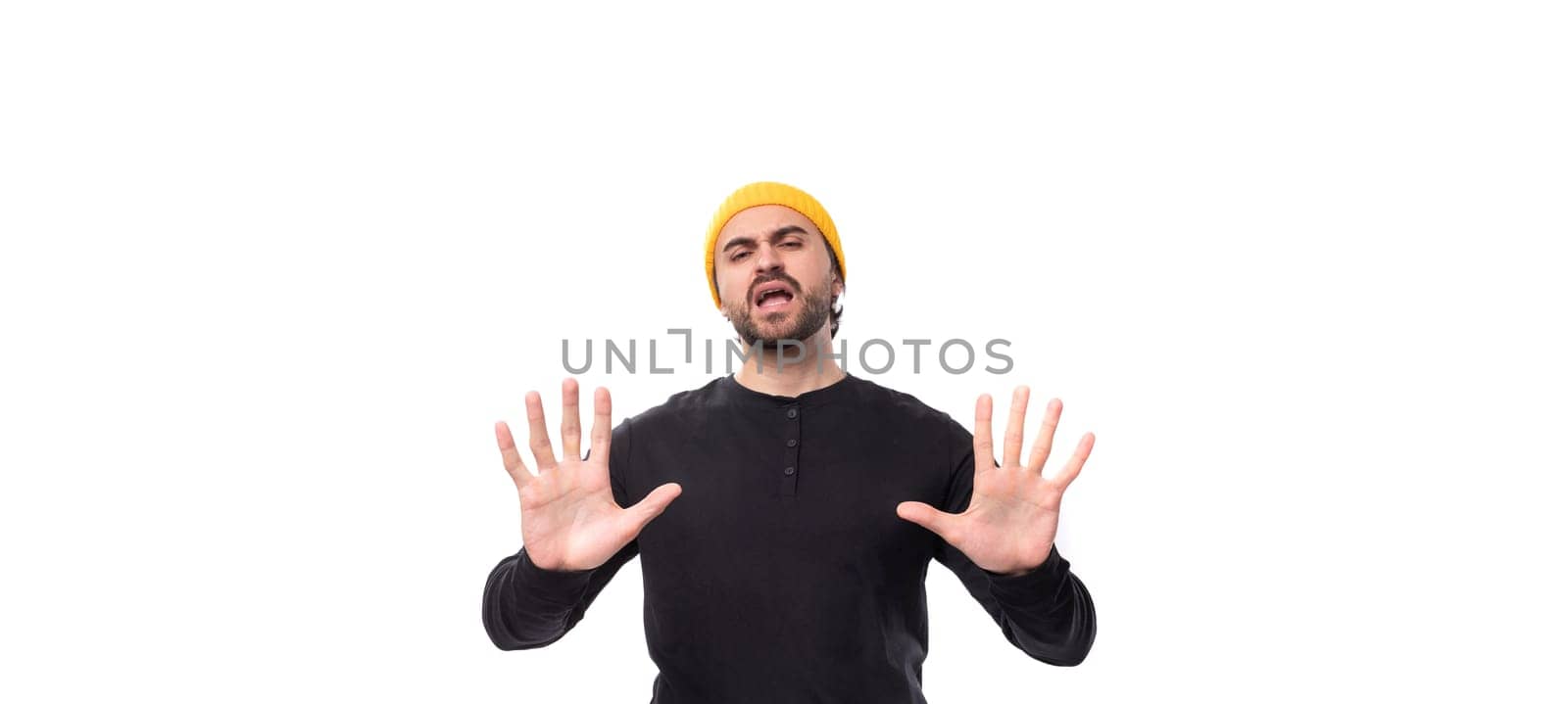 young caucasian brunette man with a beard in a casual sweatshirt has doubts.