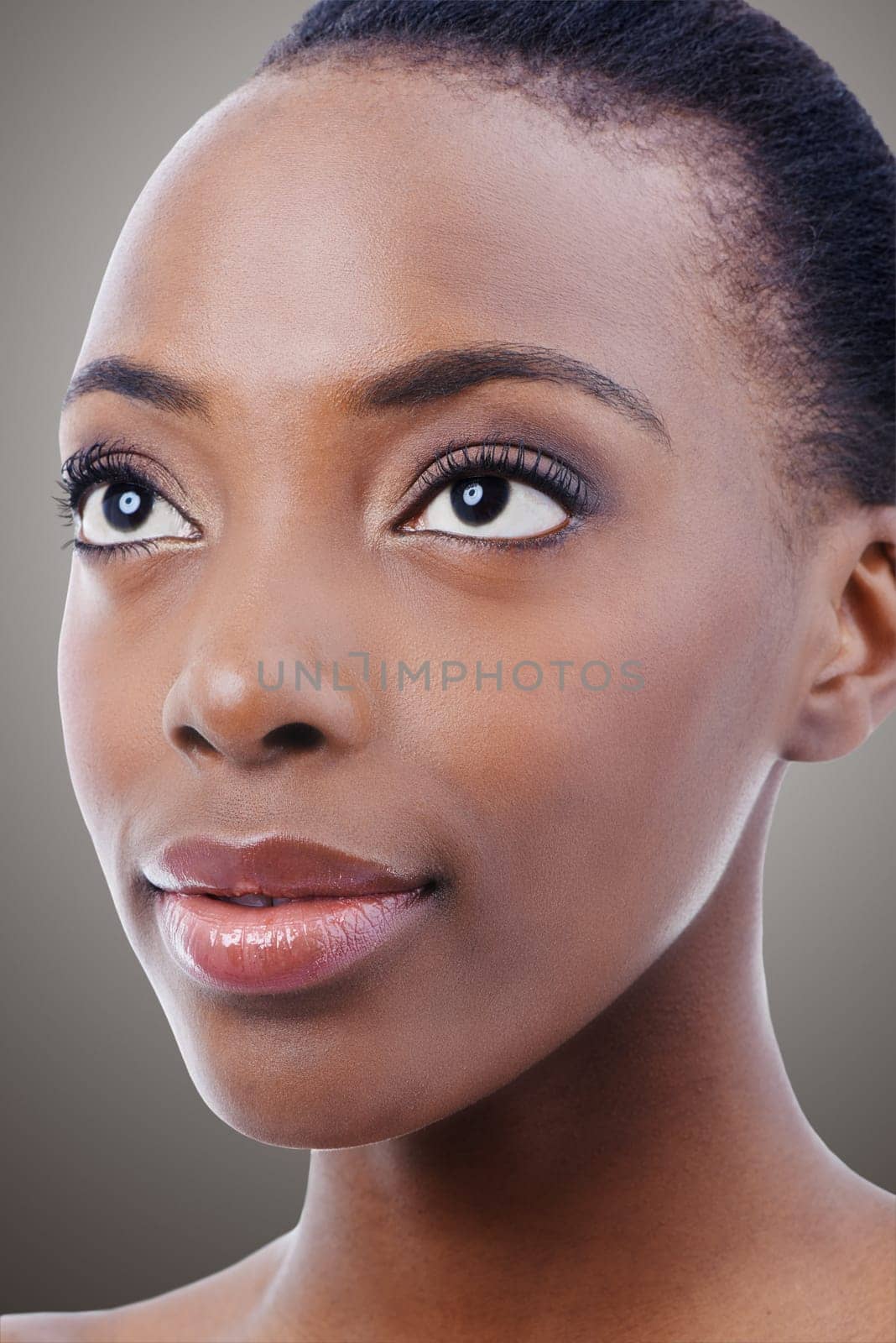 Beauty pure and simple. Studio beauty shot of an attractive ethnic model isolated on gray