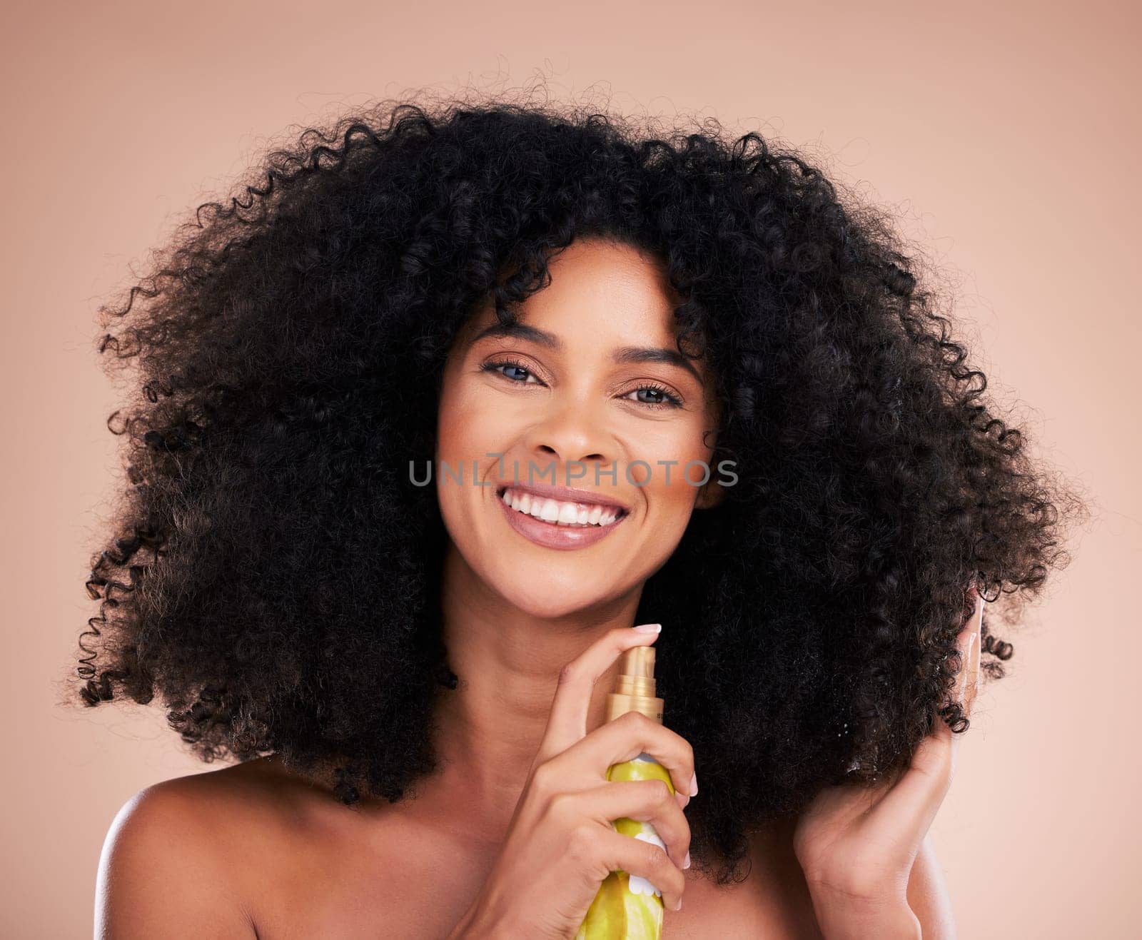 Model, portrait or afro hair product on isolated studio background in frizz control, curly management or oil treatment. Happy black woman, face or natural haircare spray in texture wellness grooming.