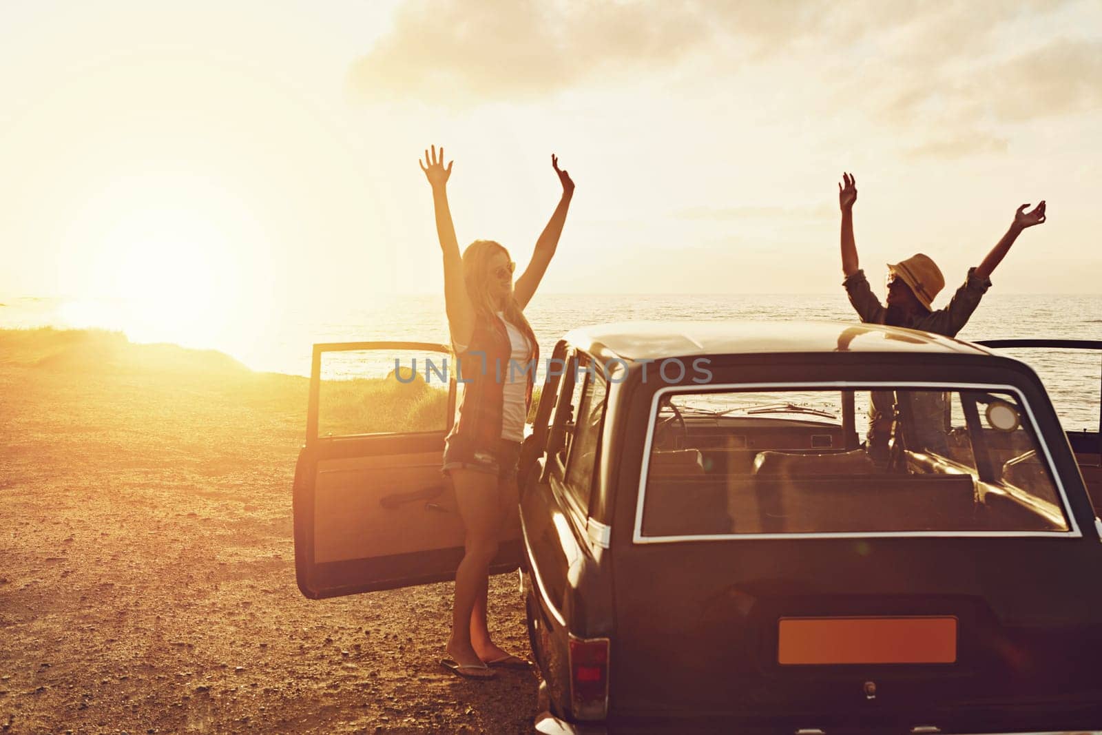 Road trip, couple of friends and sunset beach for travel, journey and summer holiday celebration. Celebrate, arms in air and vintage, retro car for outdoor vacation, parking and nature drive by ocean by YuriArcurs