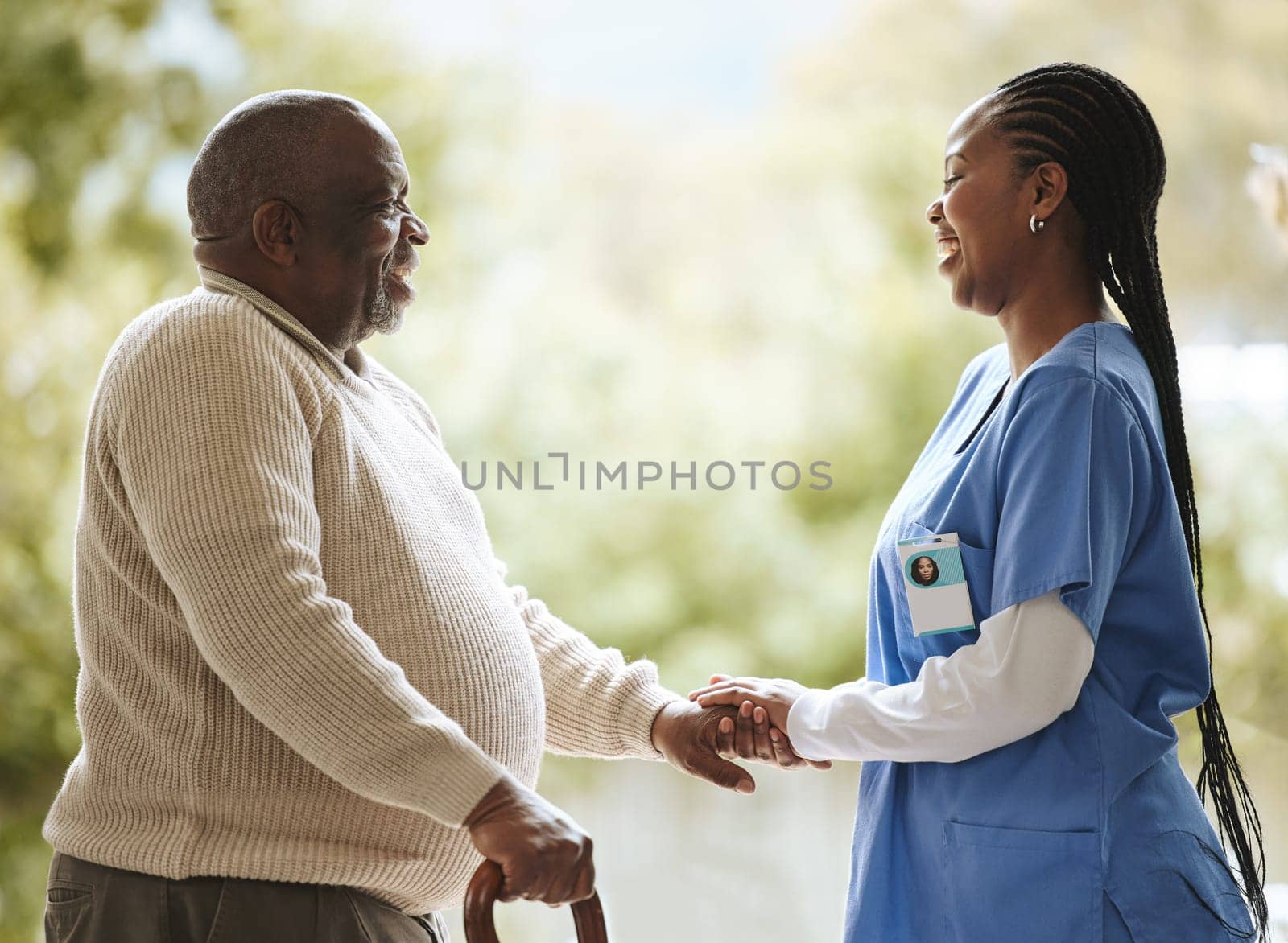 Senior man, caregiver and holding hands for support, healthcare and happiness at retirement home. Elderly patient and black woman or nurse together for trust, hope and help for health and wellness by YuriArcurs