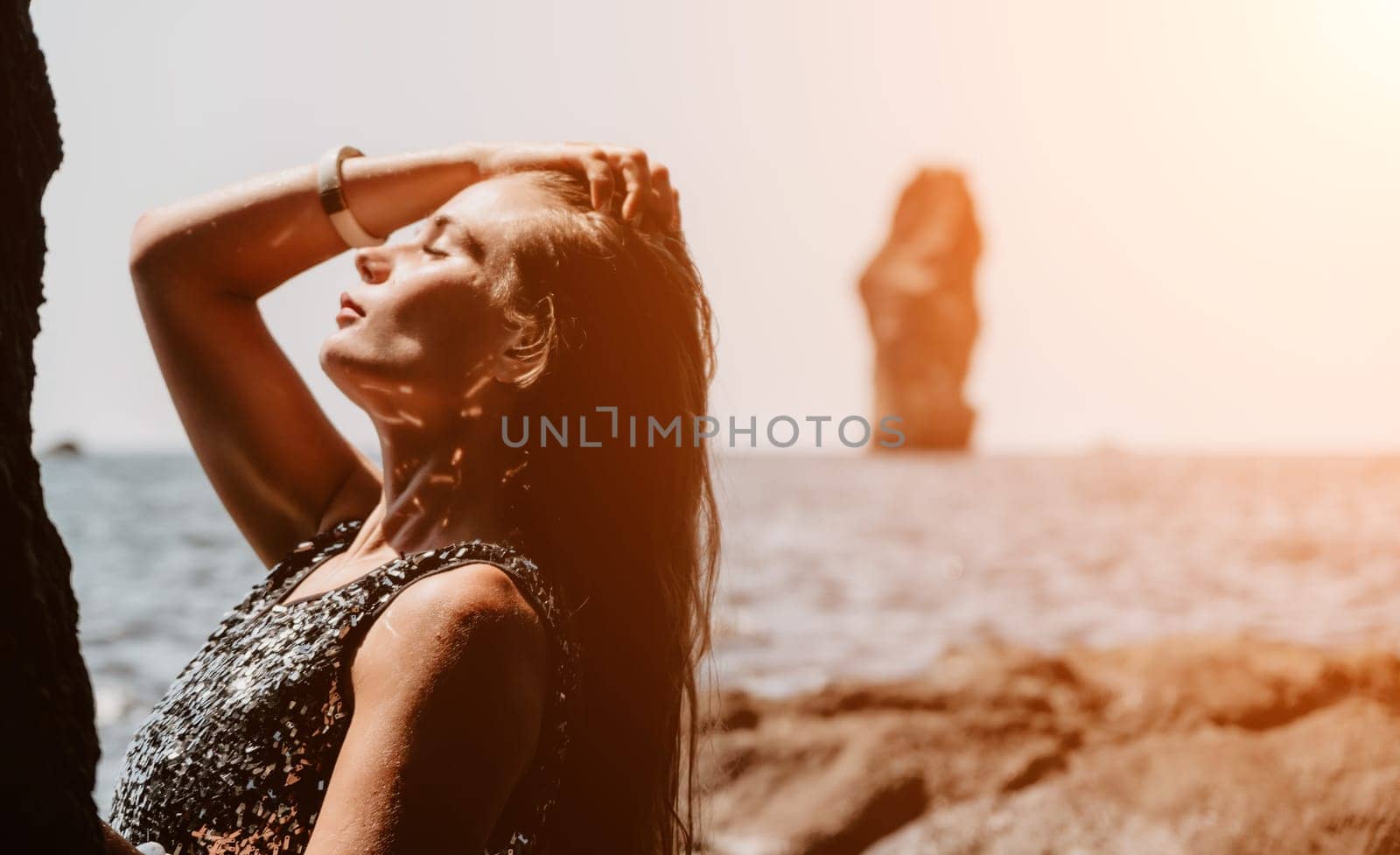 Woman summer travel sea. Happy tourist enjoy taking picture outdoors for memories. Woman traveler posing on the beach at sea surrounded by volcanic mountains, sharing travel adventure journey by panophotograph