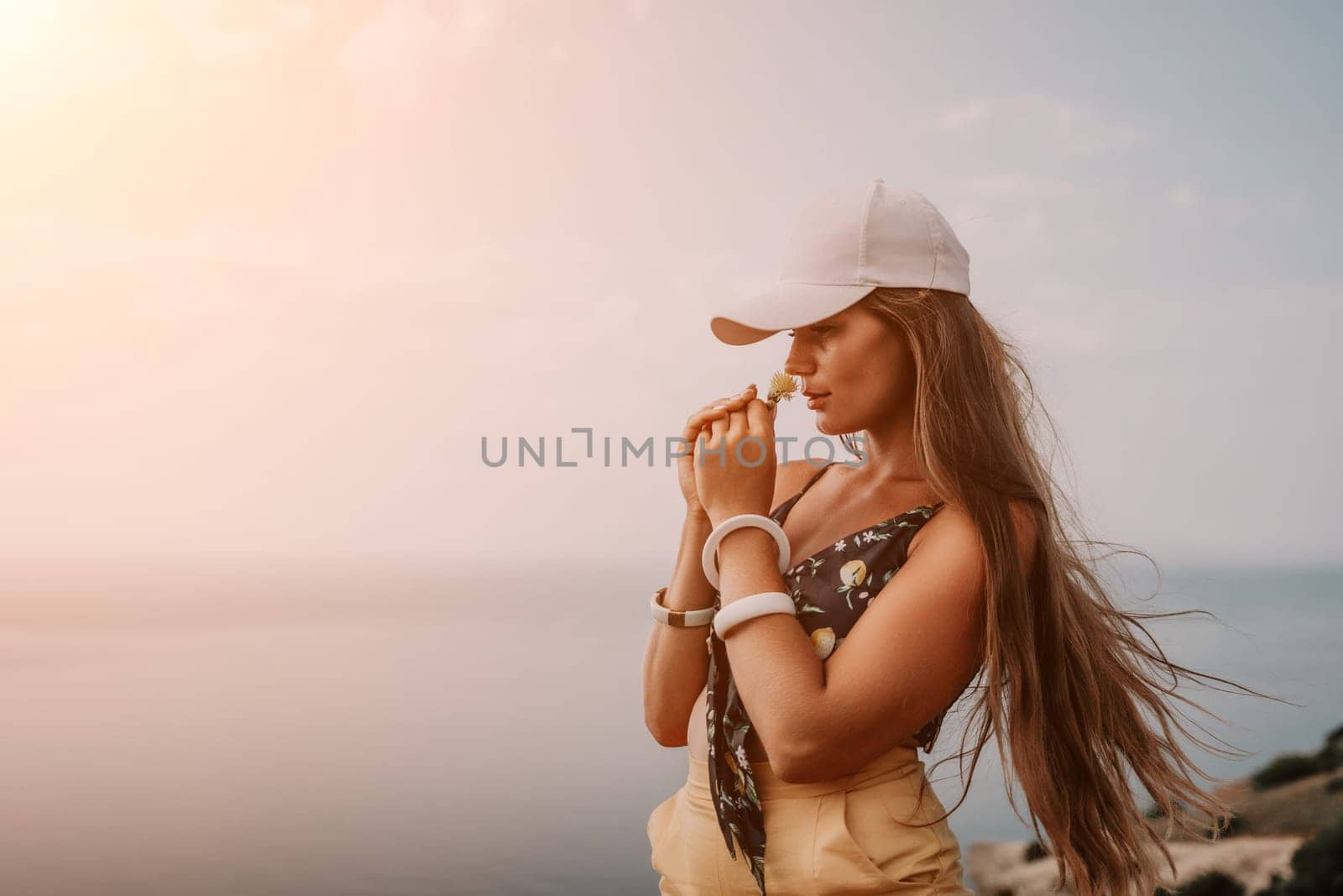 Woman travel sea. Happy tourist taking picture outdoors for memories. Woman traveler looks at the edge of the cliff on the sea bay of mountains, sharing travel adventure journey by panophotograph