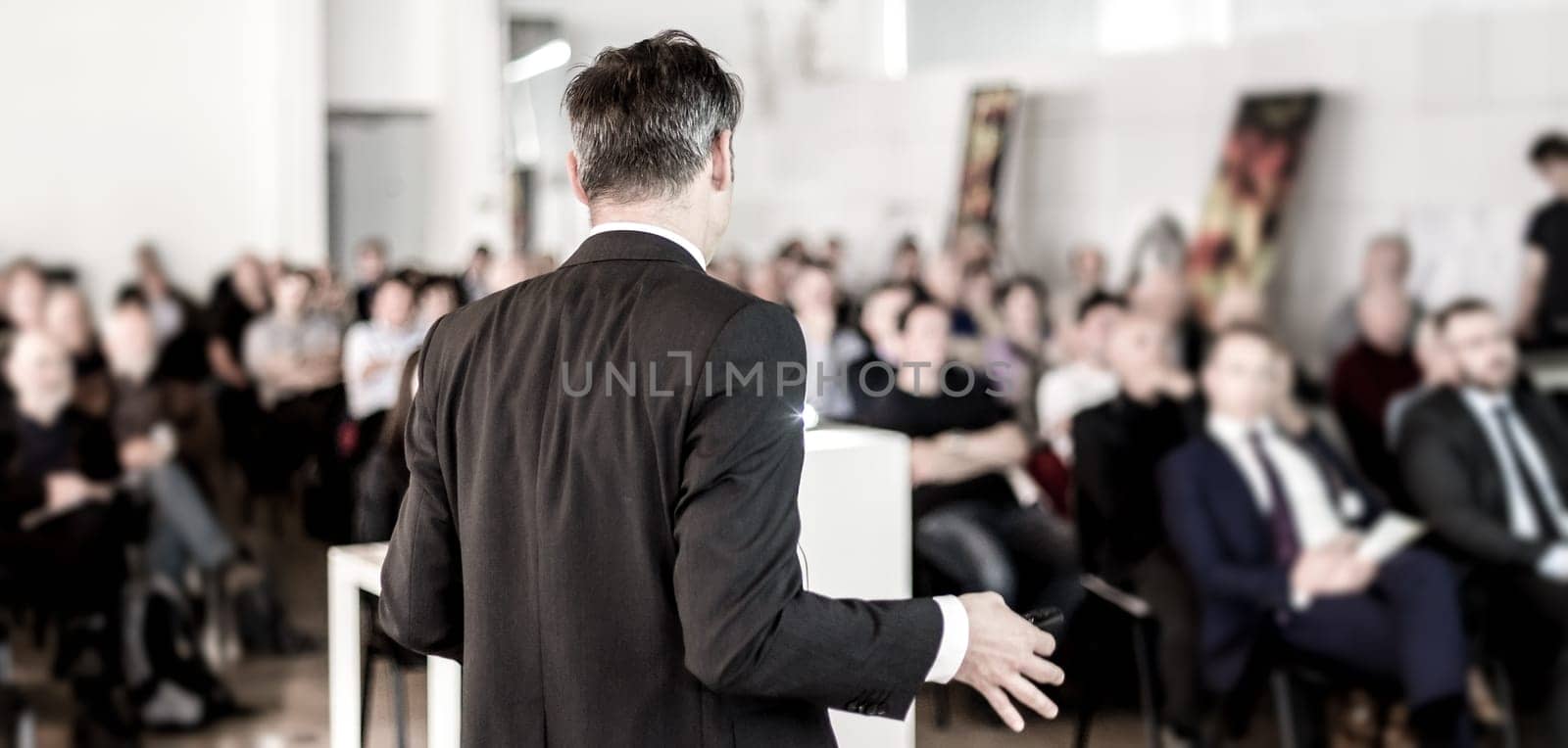 Speaker at Business Conference with Public Presentations. Audience at the conference hall. Business and Entrepreneurship concept. Background blur. Shallow depth of field.