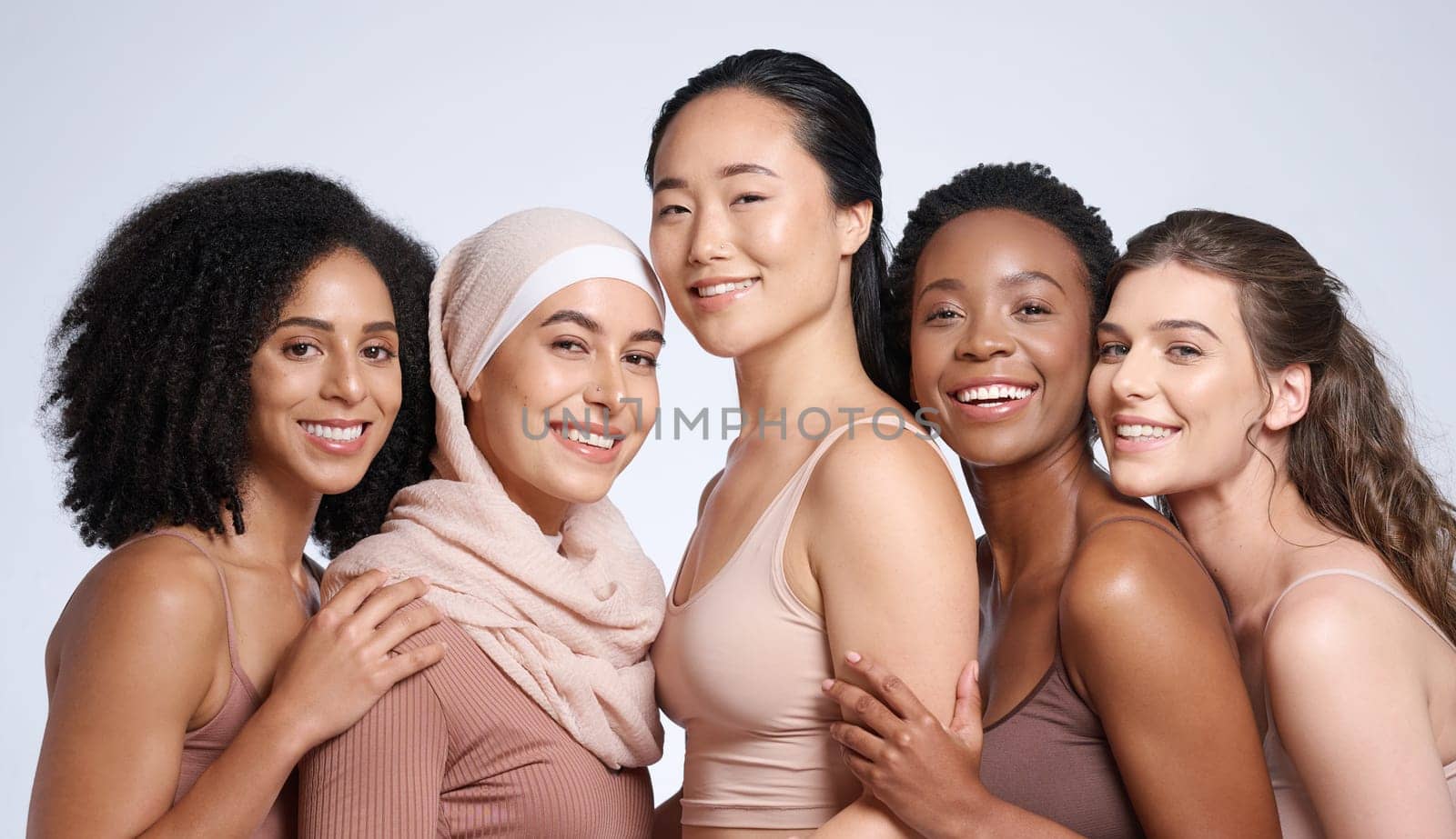 Diversity, woman and beauty portrait for body positive support, happiness and skincare wellness. Interracial models, happiness solidarity and smile for skin glow, cosmetics dermatology in studio by YuriArcurs