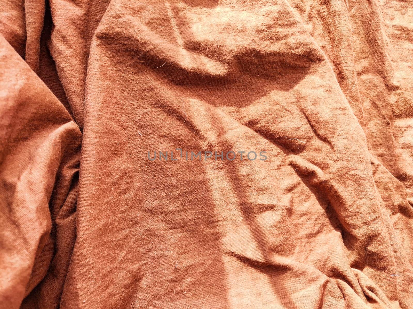 Abstract background and texture of crumpled brown fabric. Texture, pattern, frame and copy space