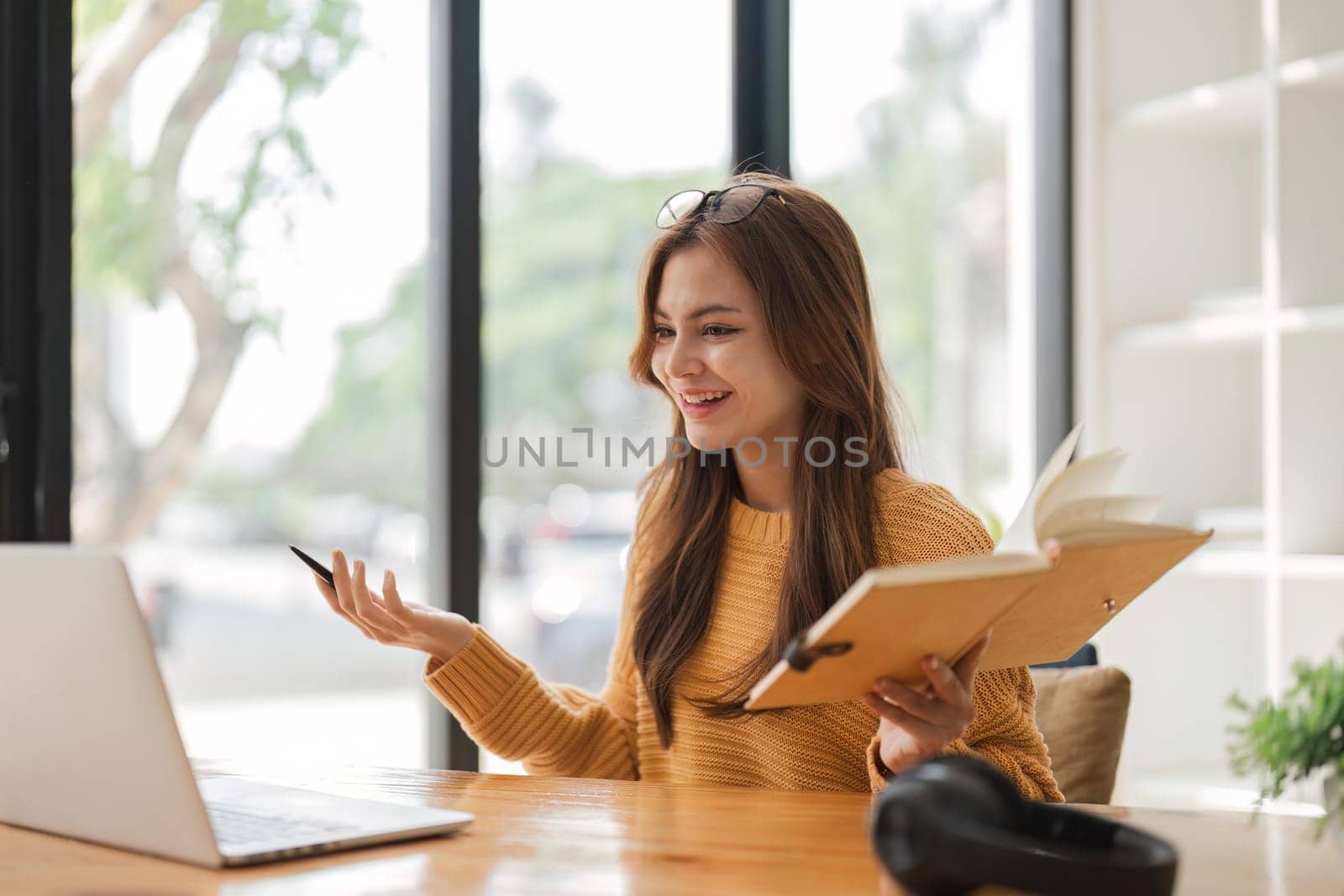 girl using laptop at home looking at screen typing chatting reading writing email. Young woman having virtual meeting online chat video call conference. Work learning from home by nateemee