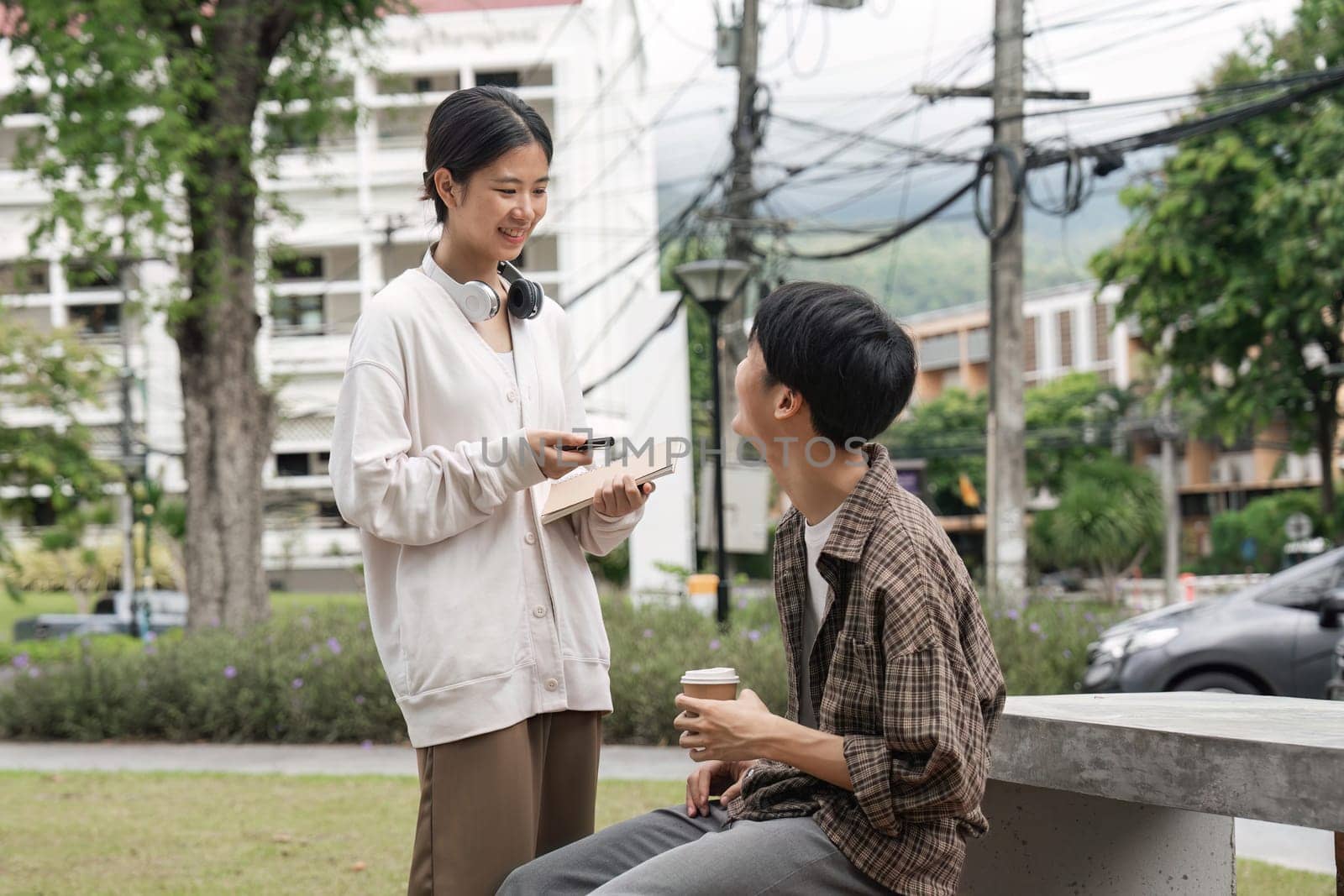 friends or students on university desk talking or speaking of future goals or education on campus. Diversity, school or happy young people in university or college bonding in fun conversation.