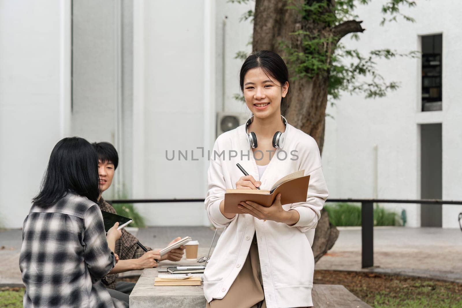 Portrait of a young, beautiful, intelligent and attractive Asian student woman smiling in her campus.