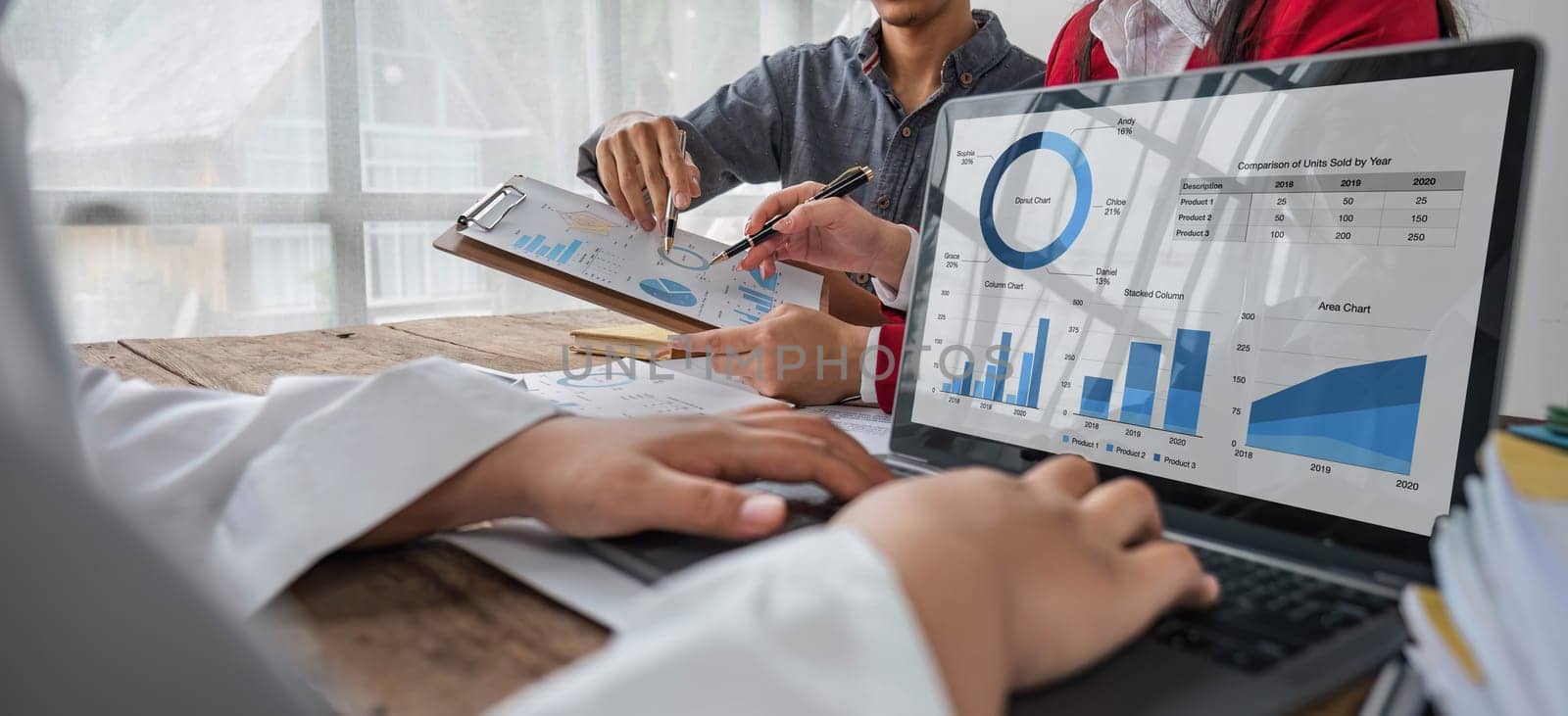 Business People Meeting using laptop computer,calculator,notebook,stock market chart paper for analysis Plans to improve quality next month. Conference Discussion Corporate Concept