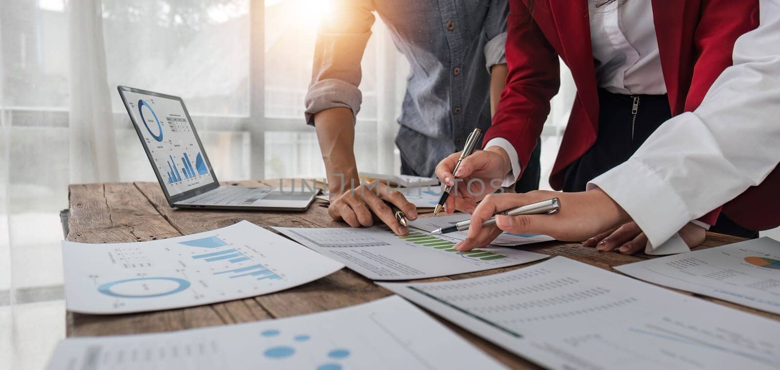 Business People Meeting using laptop computer,calculator,notebook,stock market chart paper for analysis Plans to improve quality next month. Conference Discussion Corporate Concept