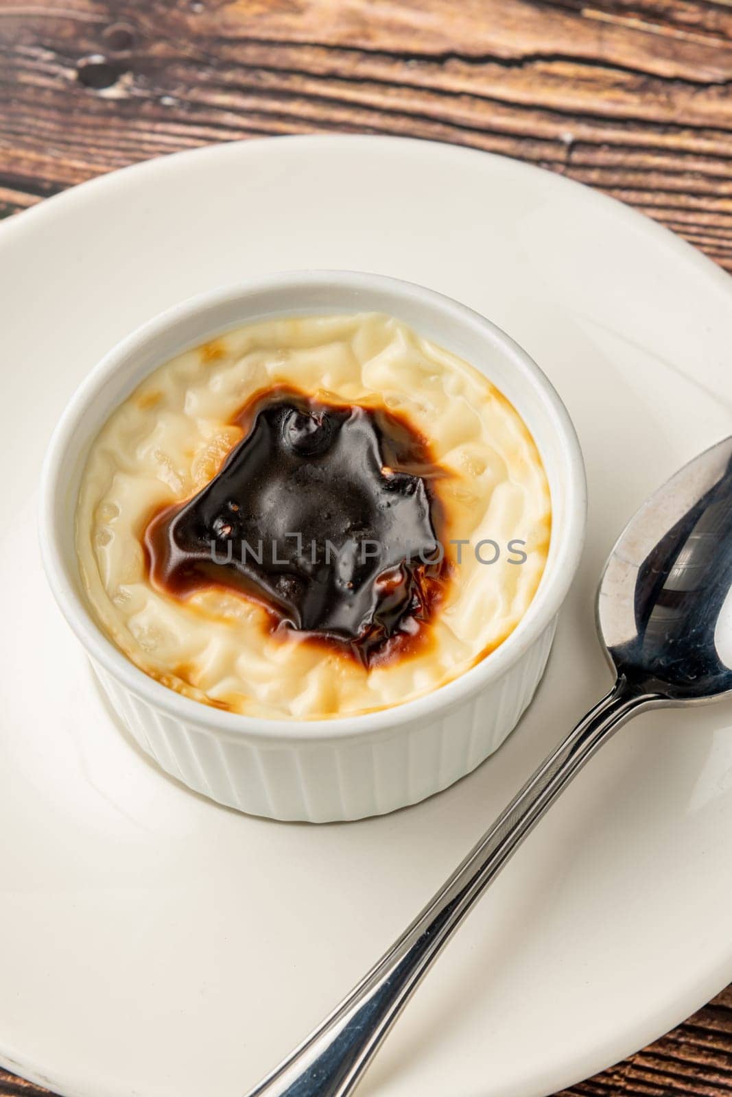 Traditional turkish dessert bakery rice pudding Turkish name Firin Sutlac in ceramic bowl by Sonat