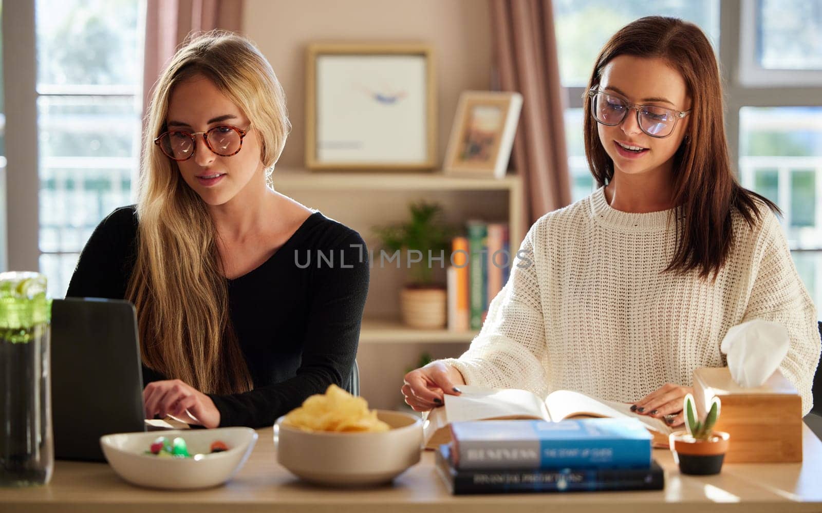 Home, students and women studying, education and knowledge for success, test and distance learning. Female friends, academic and girls with laptop, books and growth with preparation for exam or focus by YuriArcurs