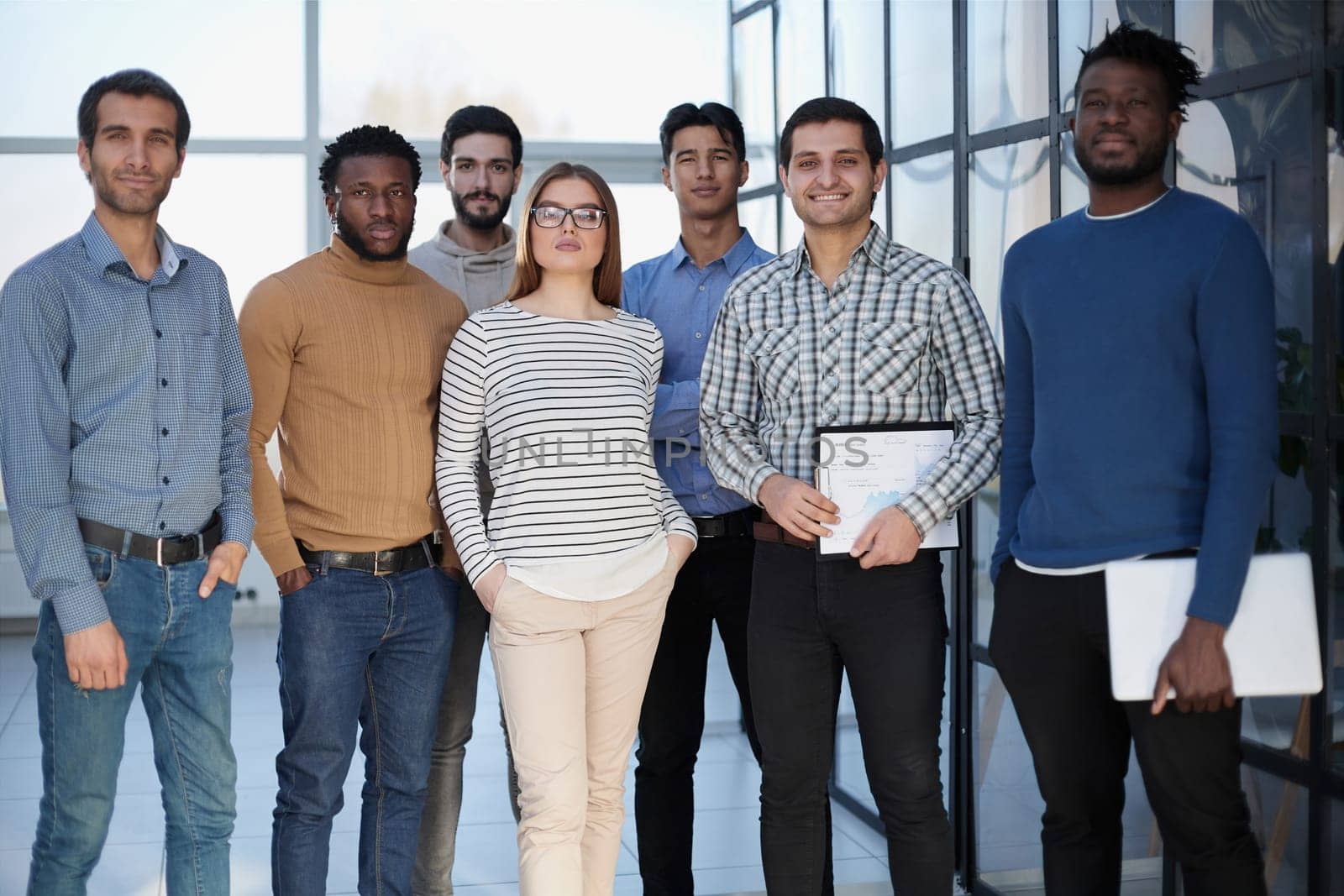 Business people in elegant casual clothes are standing in the office
