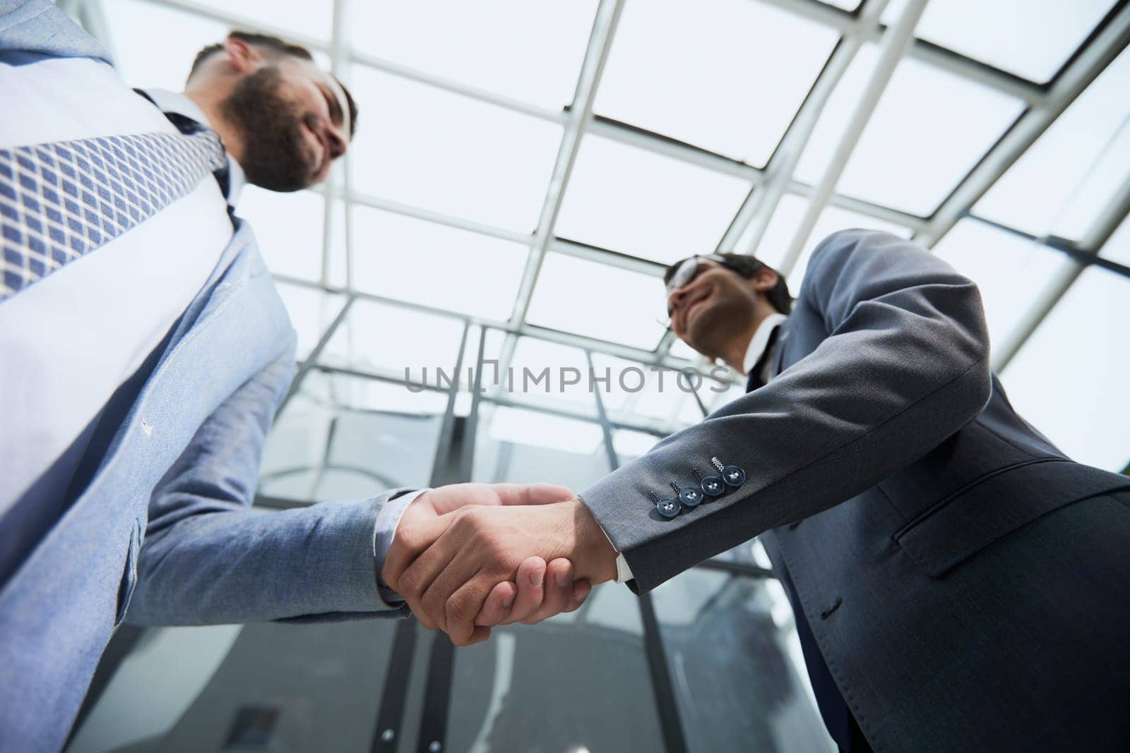 Business partners shake hands in the office