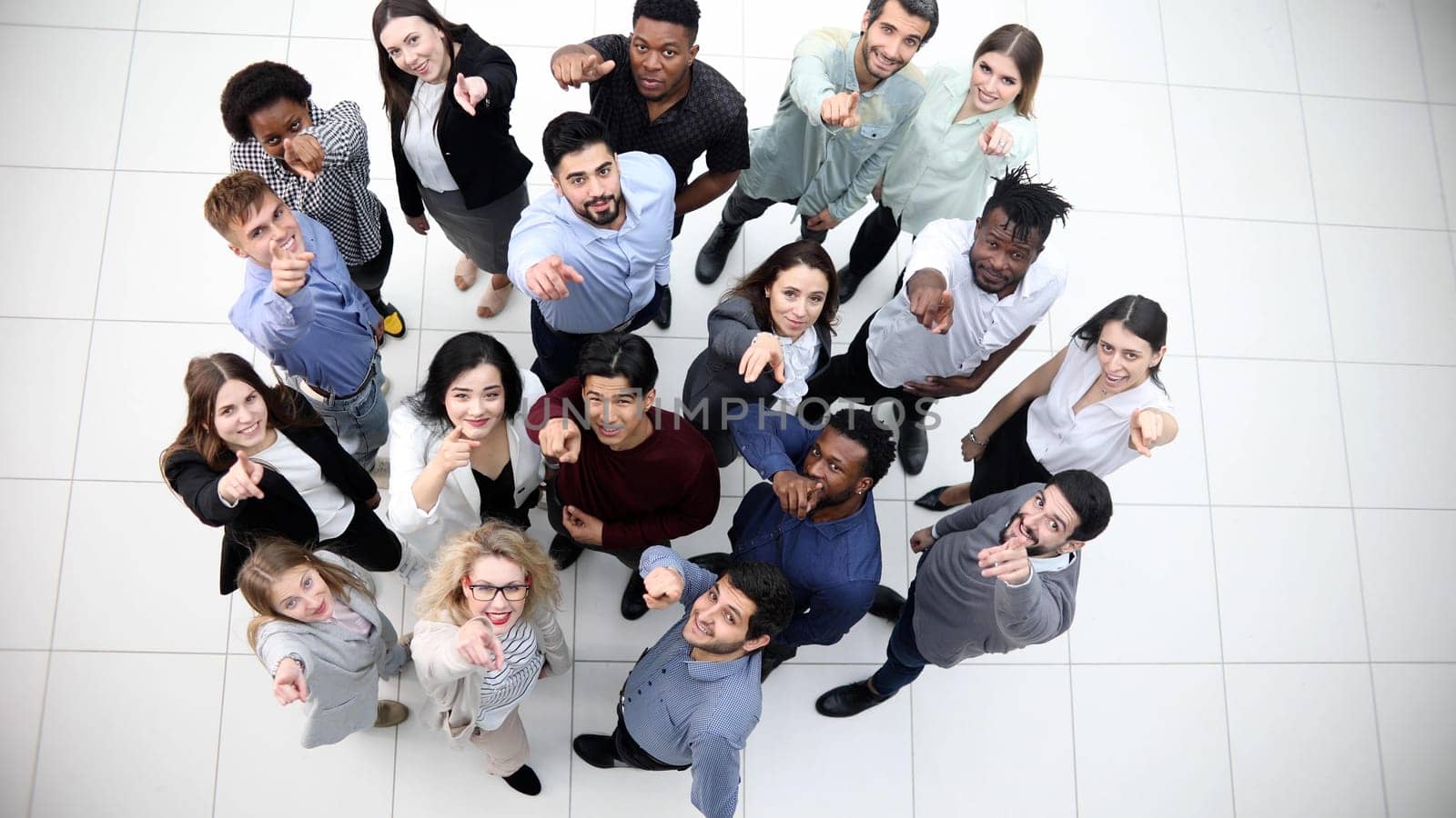 multicultural successful business group looking up in office corridor by Prosto