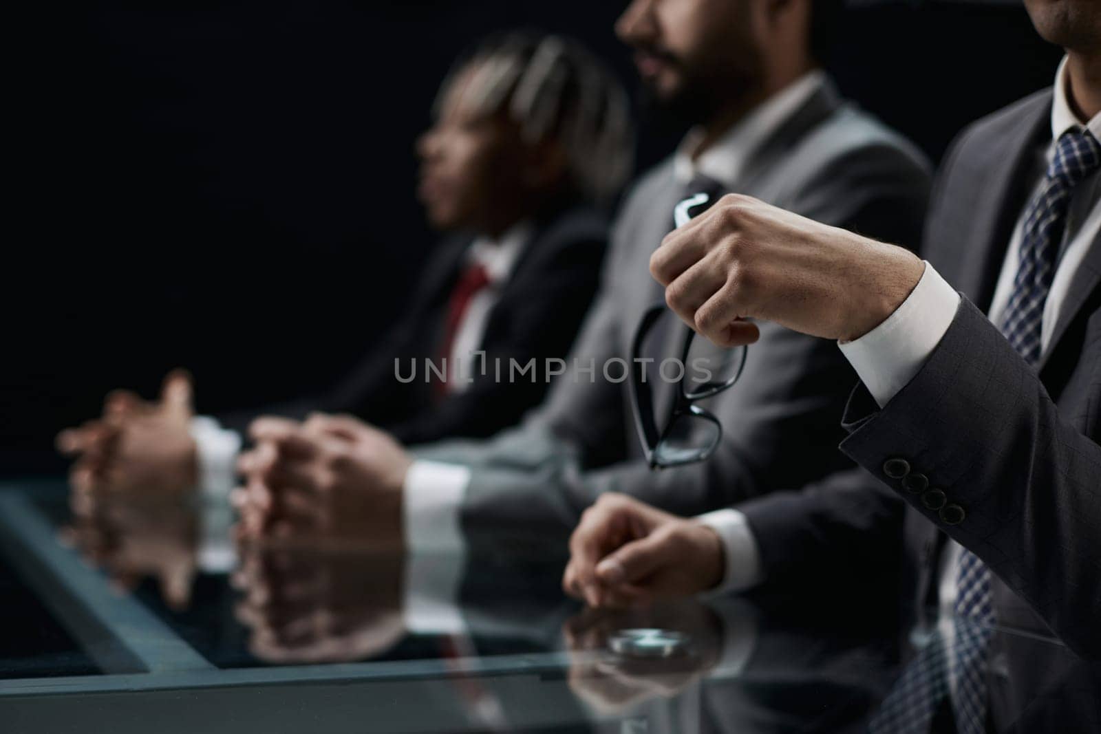 Business partners discuss financial reports, plan an investment strategy. Team of three