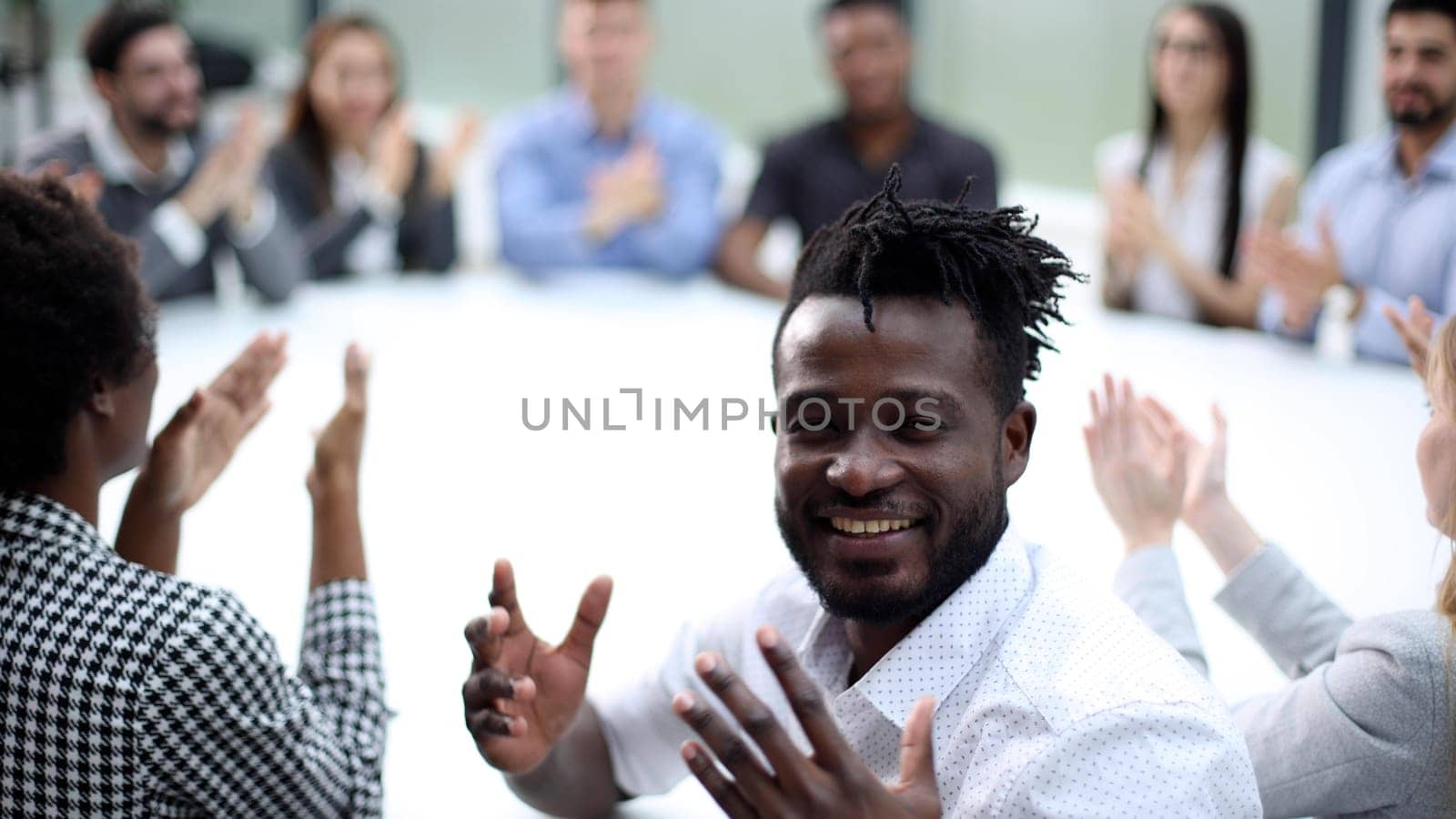 Businesspeople laughing together during a meeting in an office