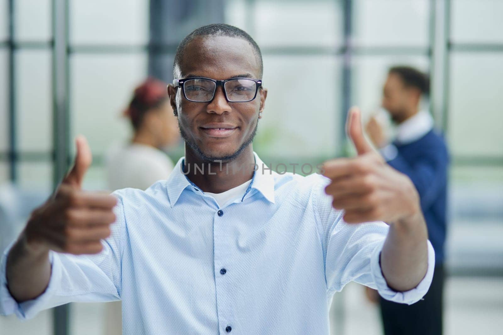 Portrait of happy afroamerican handsome man and showing thumb up gesture
