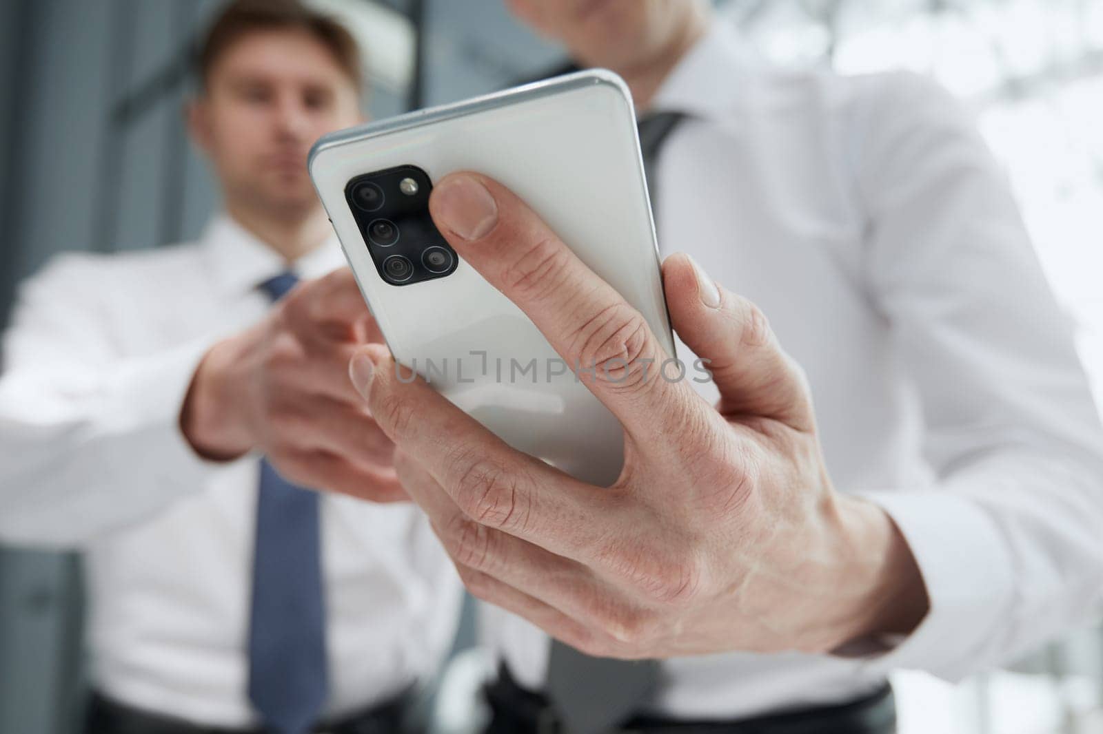 man using smartphone pressing finger, reading social media internet, typing text or shopping online. Mobile phone at home or work.