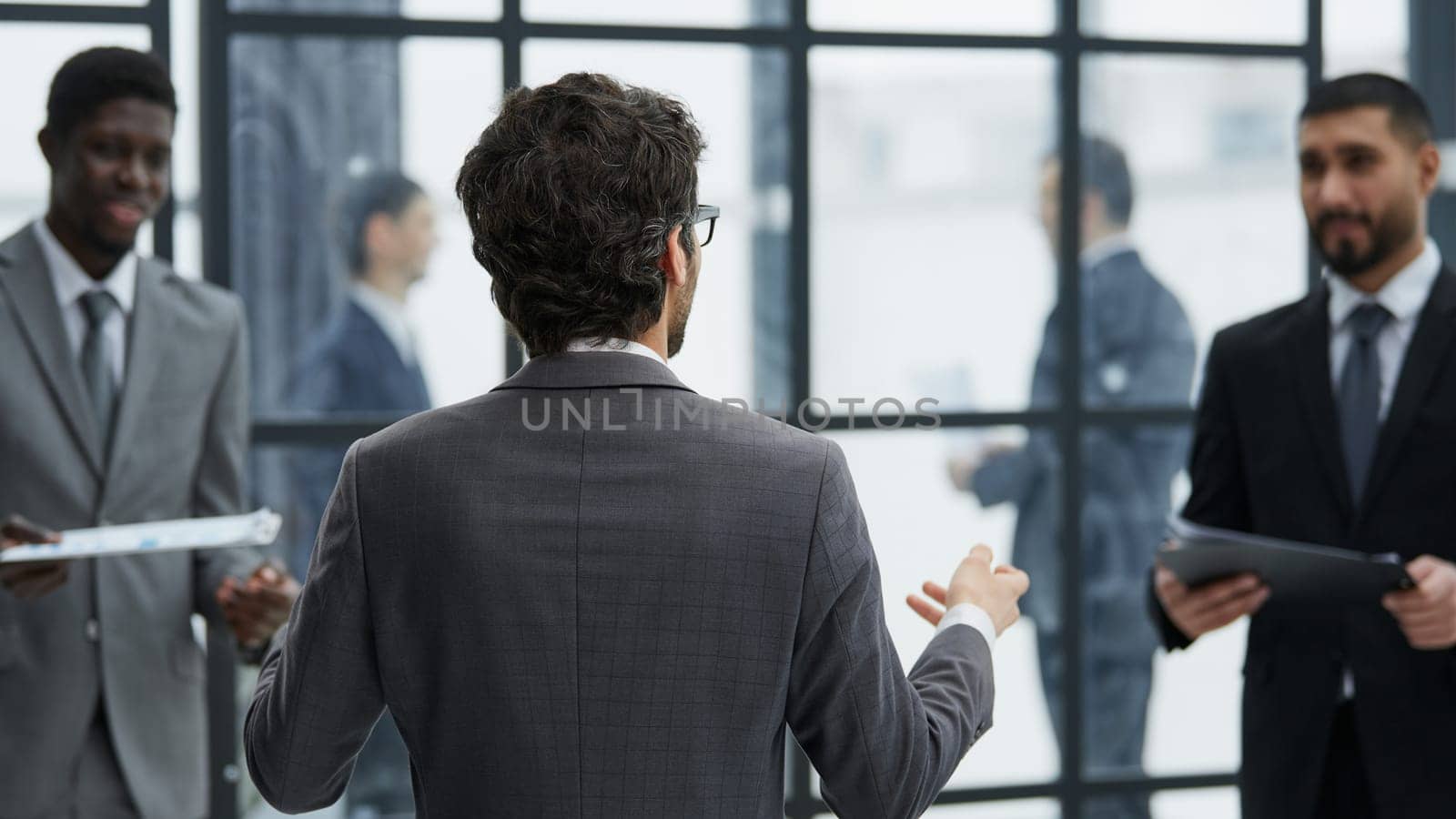 presentation with his colleagues during a meeting in an office boardroom