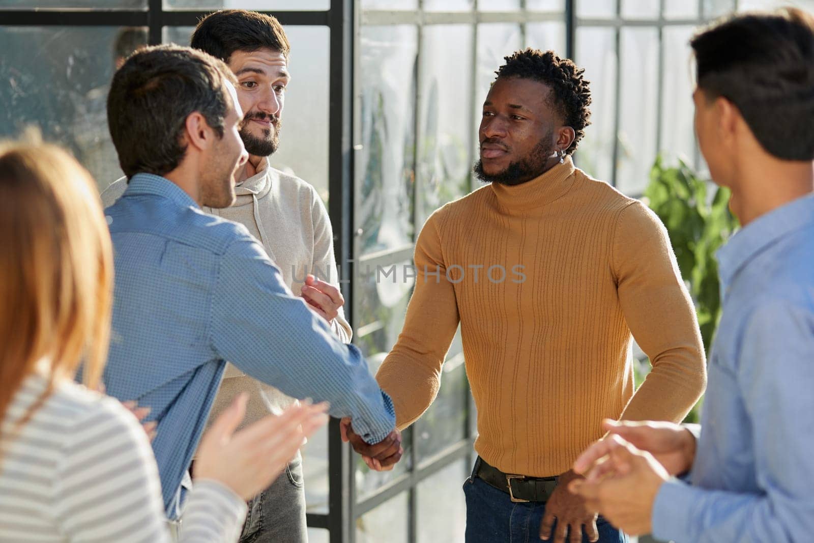 Shot of a happy businessman welcoming his new colleague to the team during a meeting in the boardroom.