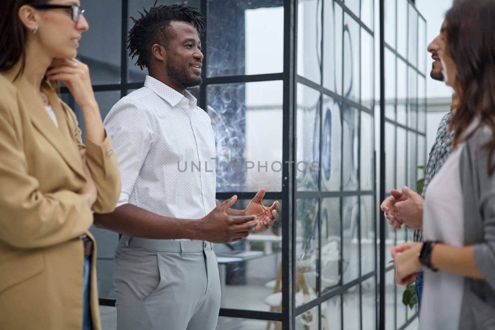 Laughing multiethnic business people talking in the office.