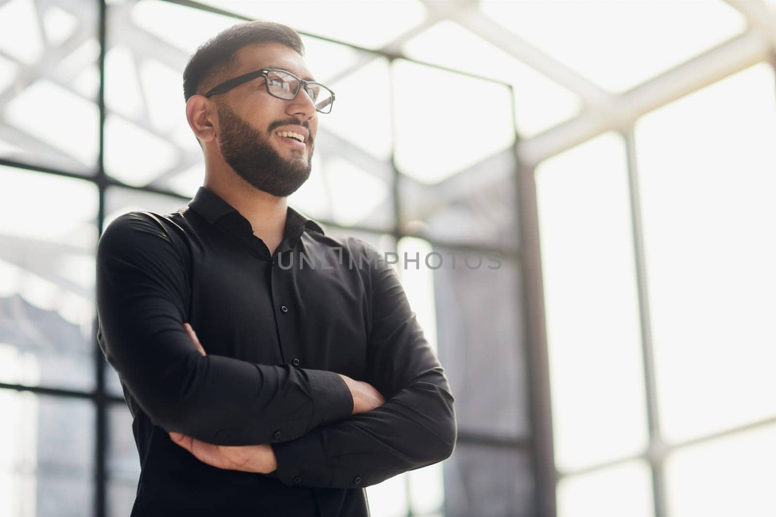 Businessman portrait. Happy confident young businessman standing , smiling, looking at camera.