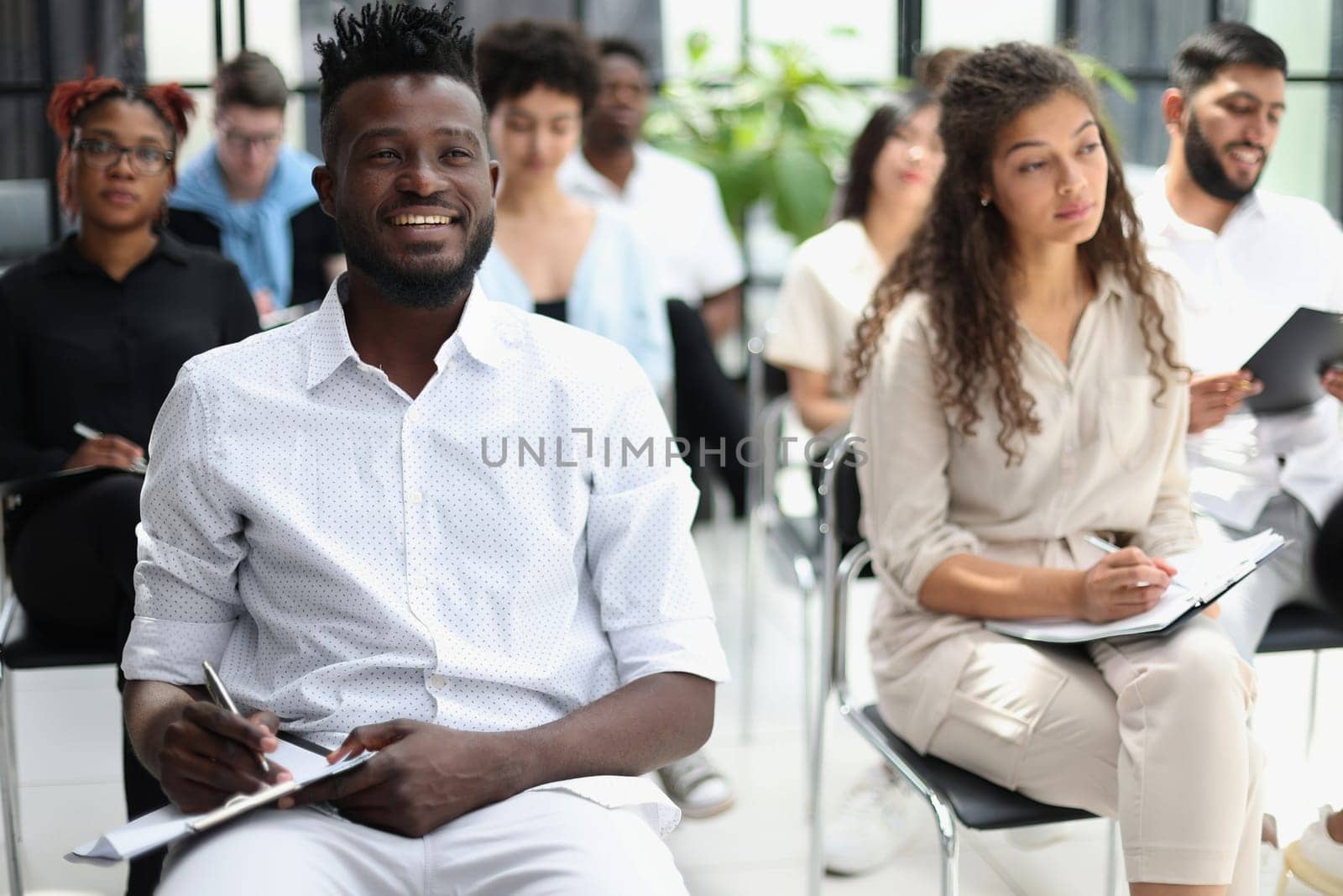 Audience at the conference hall. Business and Entrepreneurship concept. Focus on unrecognizable people in audience.