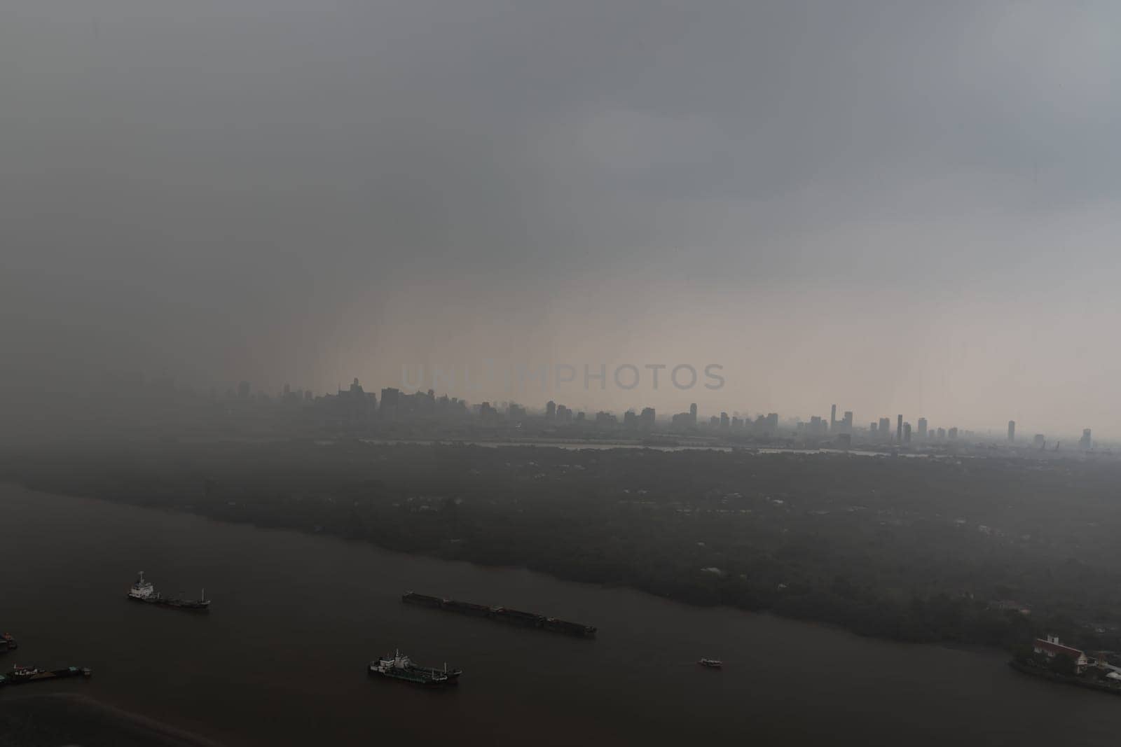 Bangkok, Thailand - May 28, 2023 - Misty Landscape of city skyscrapers covered before raining. Heavy dense smog fot during afternoon that Bangkok city cannot be seen clearly, Aerial top view of city on a foggy day, Space for text, No focus, specifically.