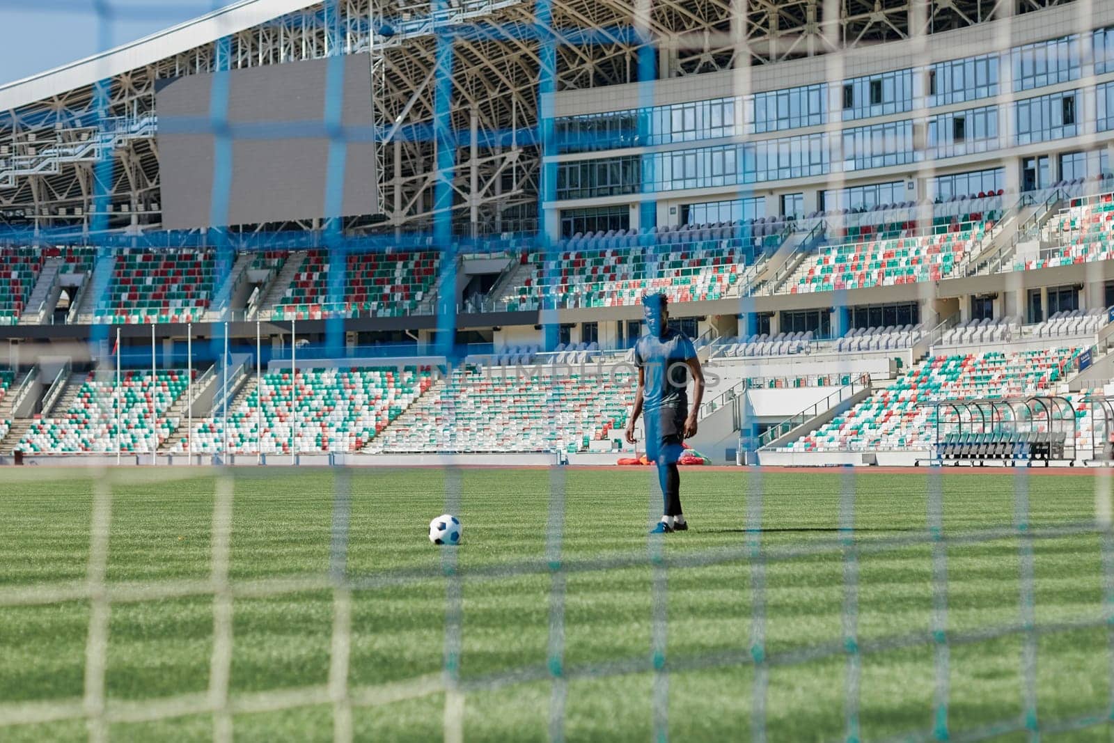 Football goal post with net, back view. Association football goal on the field