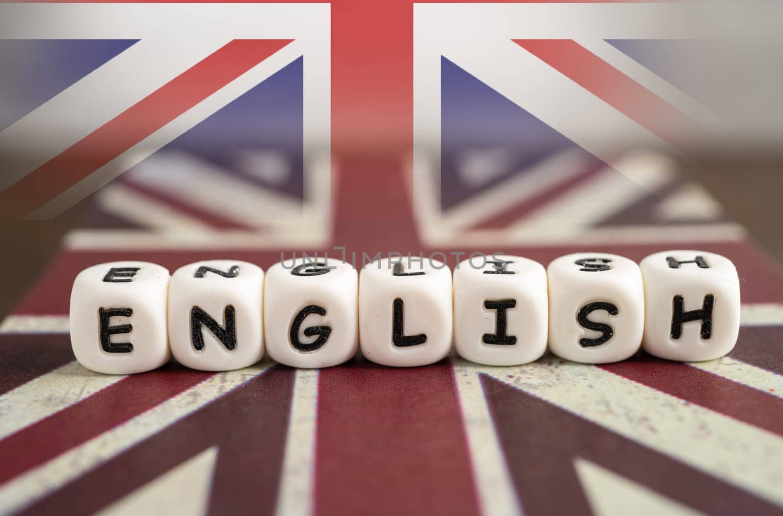 Word Learn English on book with United Kingdom flag, learning English language courses concept.