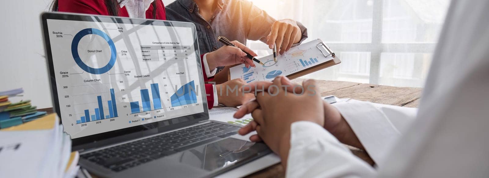 Business People Meeting using laptop computer,calculator,notebook,stock market chart paper for analysis Plans to improve quality next month. Conference Discussion Corporate Concept