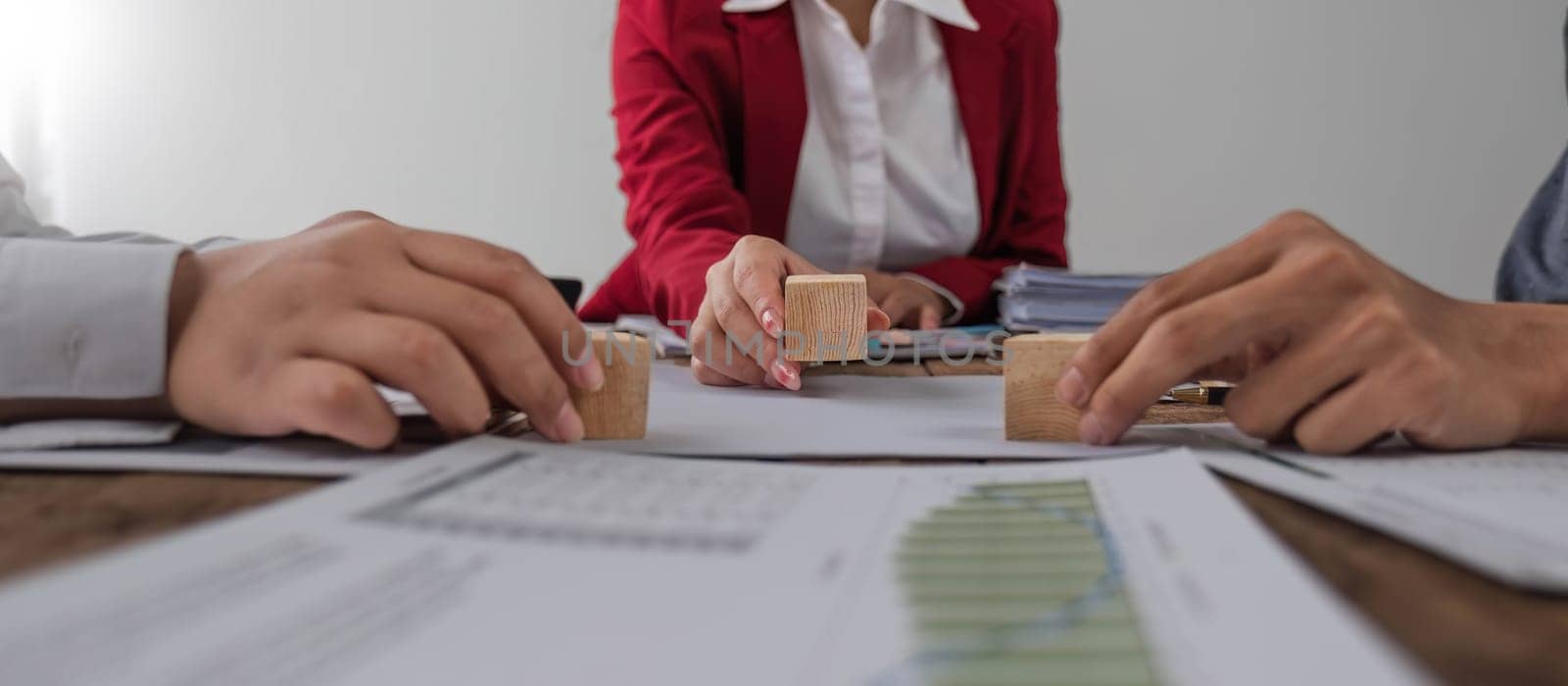 A group of business people assembling jigsaw puzzle. The concept of cooperation, teamwork, help and support in business. by wichayada