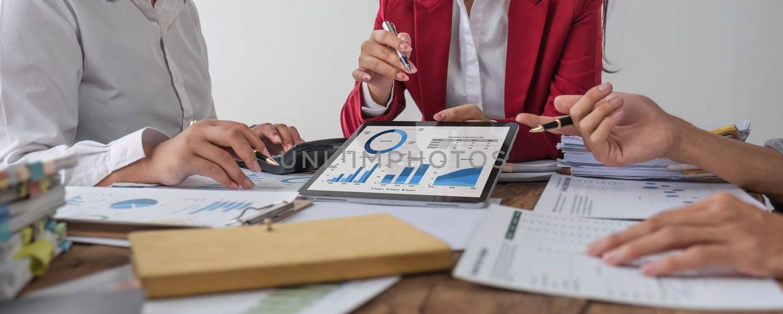 Business People Meeting using laptop computer,calculator,notebook,stock market chart paper for analysis Plans to improve quality next month. Conference Discussion Corporate Concept.. by wichayada