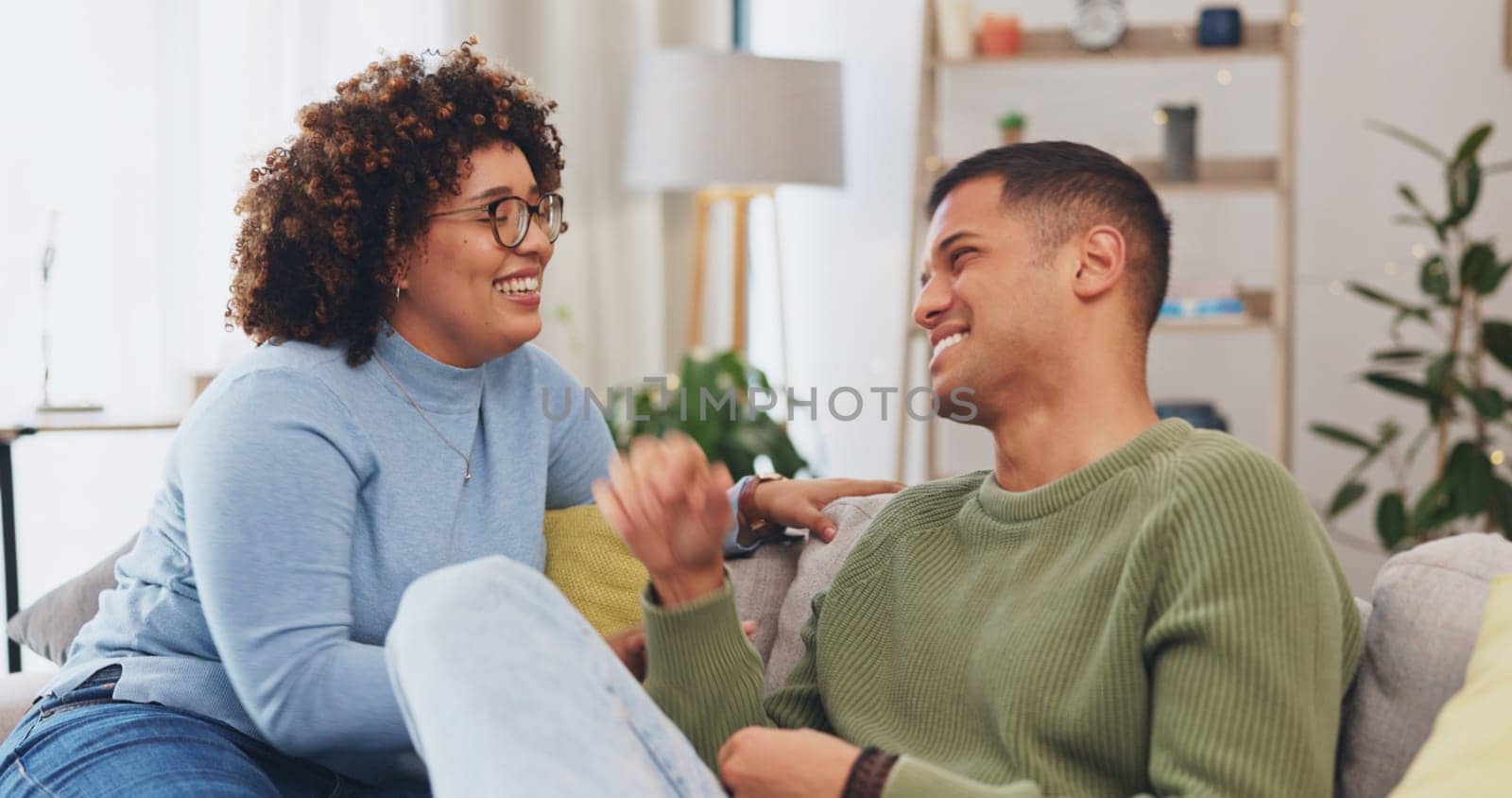 Couple have conversation, communication and funny story in living room, spending quality time together on couch. Partner, love and respect, people talking and connection with laughter and happiness.