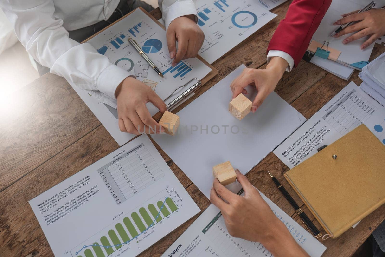 A group of business people assembling jigsaw puzzle. The concept of cooperation, teamwork, help and support in business...